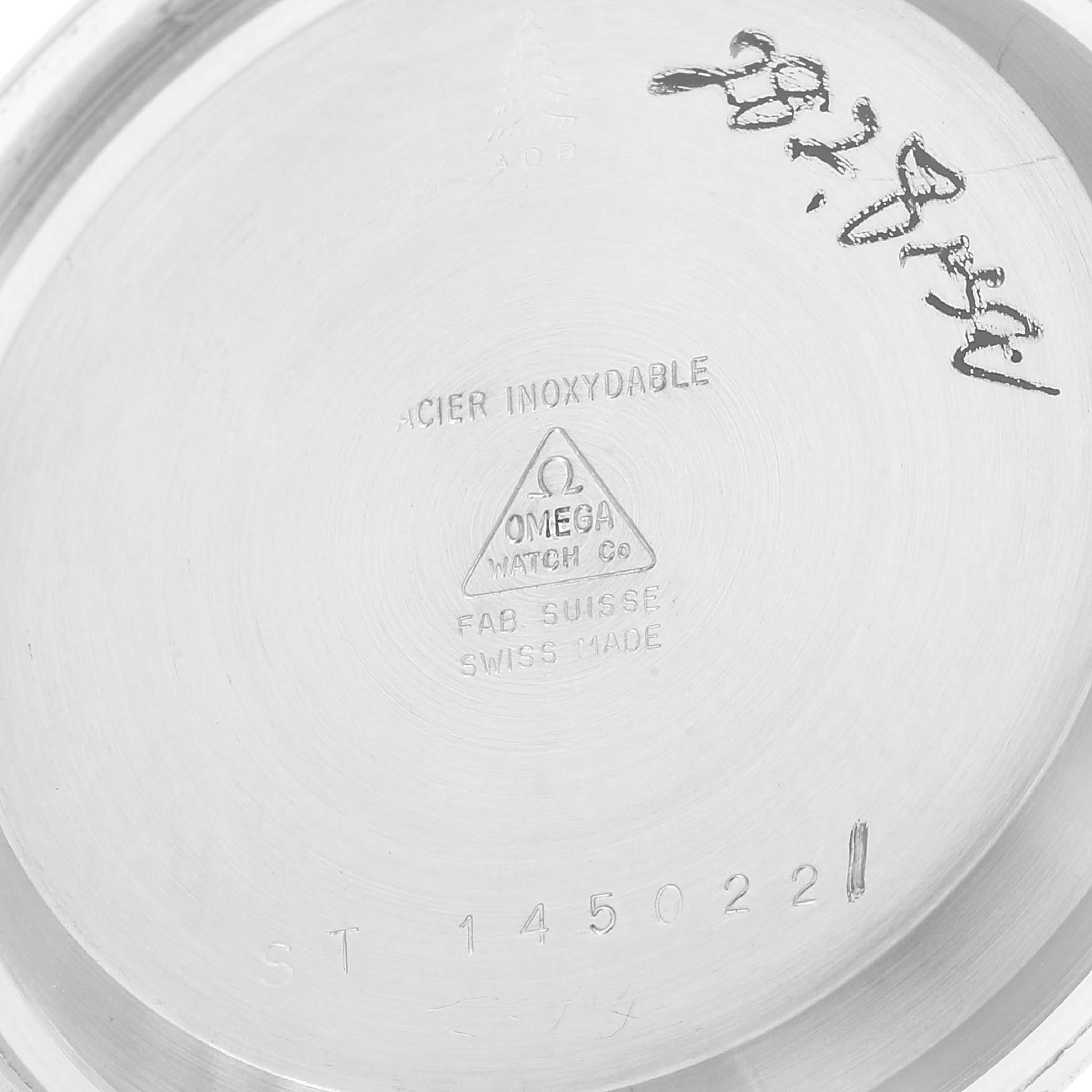 The image shows the inside case back of an Omega Speedmaster 145.022 Men's Stainless Steel Black Dial 145.022 Men's Stainless Steel Black Dial watch, highlighting the brand, model, and material information.