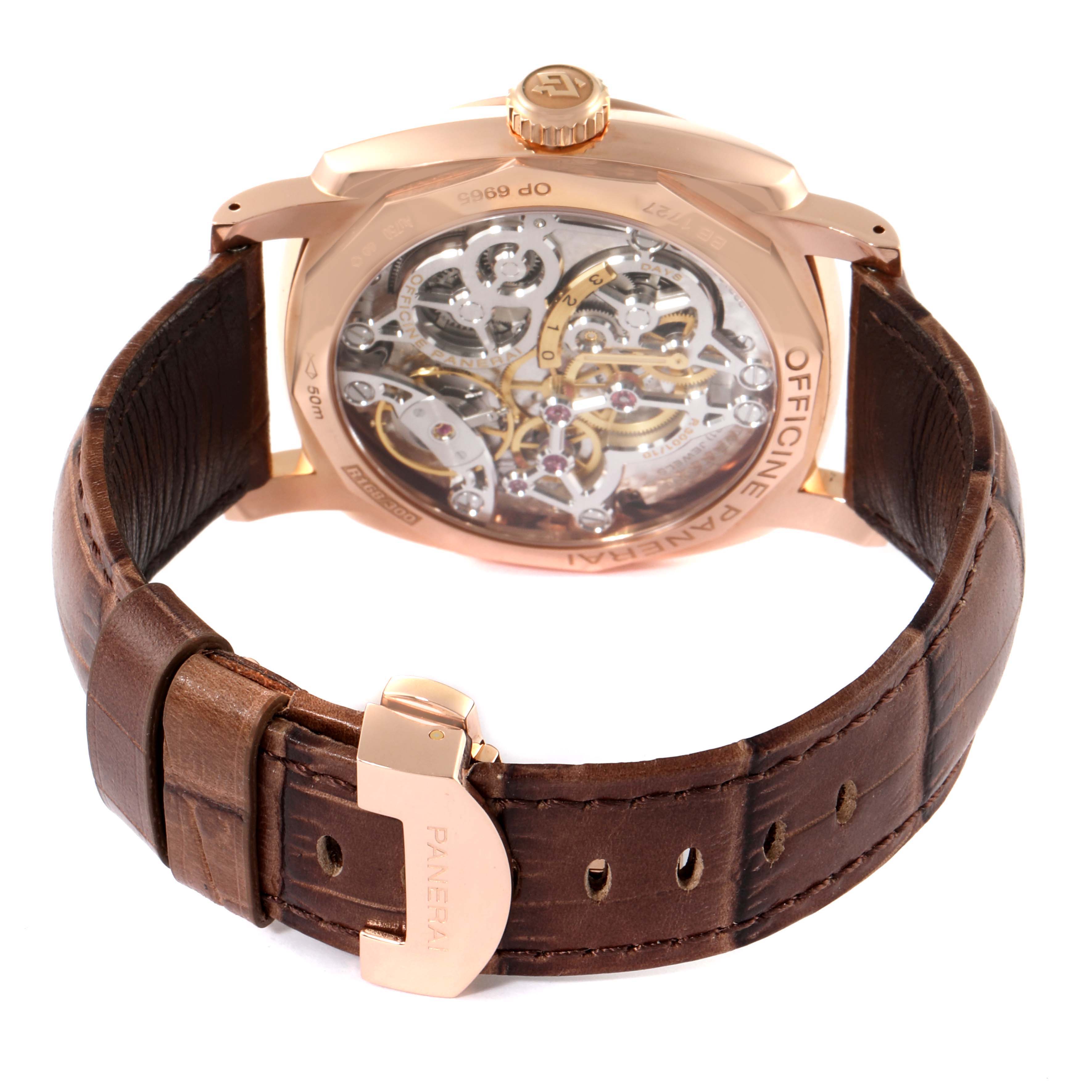 The image shows the back view of a Panerai Radiomir PAM00570 Men
s Rose Gold Brown Dial PAM00570 Men
s Rose Gold Brown Dial watch, highlighting the intricate mechanism and brown leather strap.