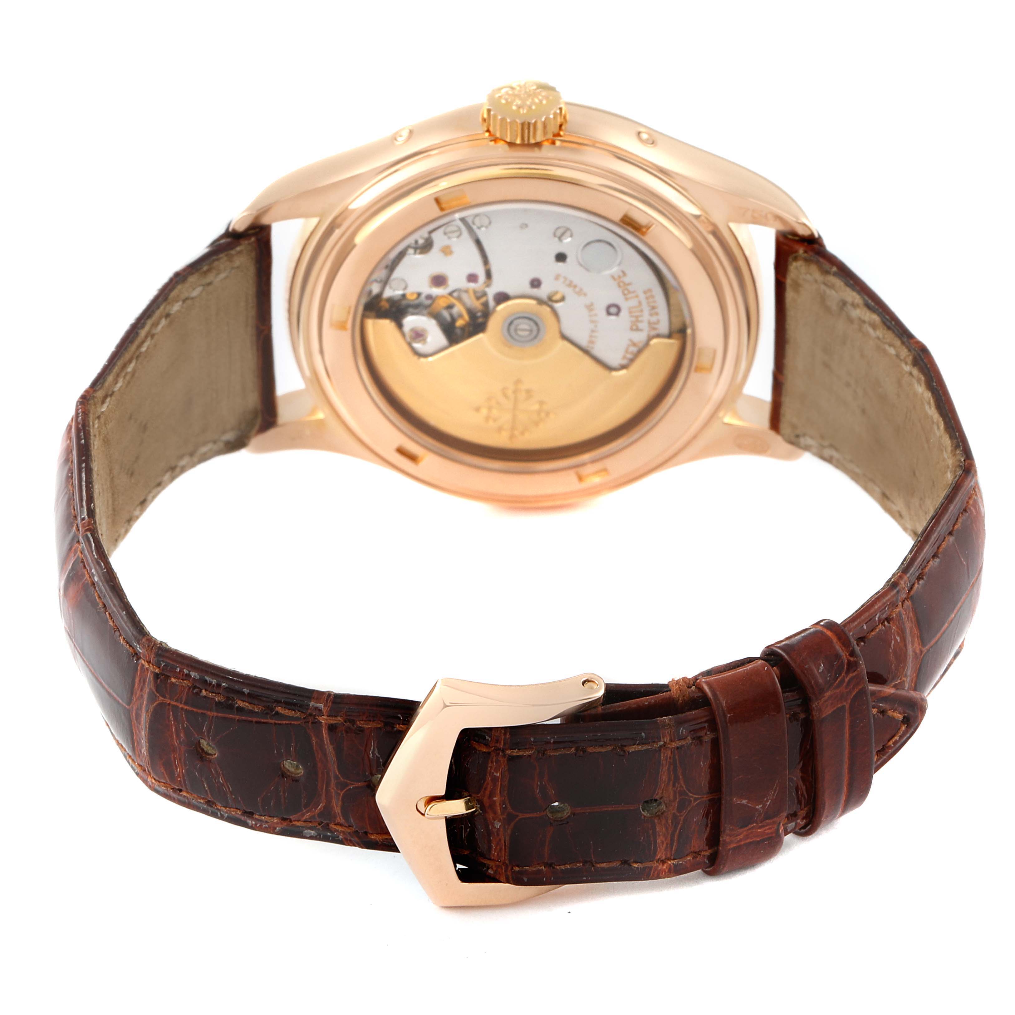The image shows the back view of the Patek Philippe Complications 5035R Men's Rose Gold Silver Dial 5035R Men's Rose Gold Silver Dial watch, highlighting its movement and brown leather strap.