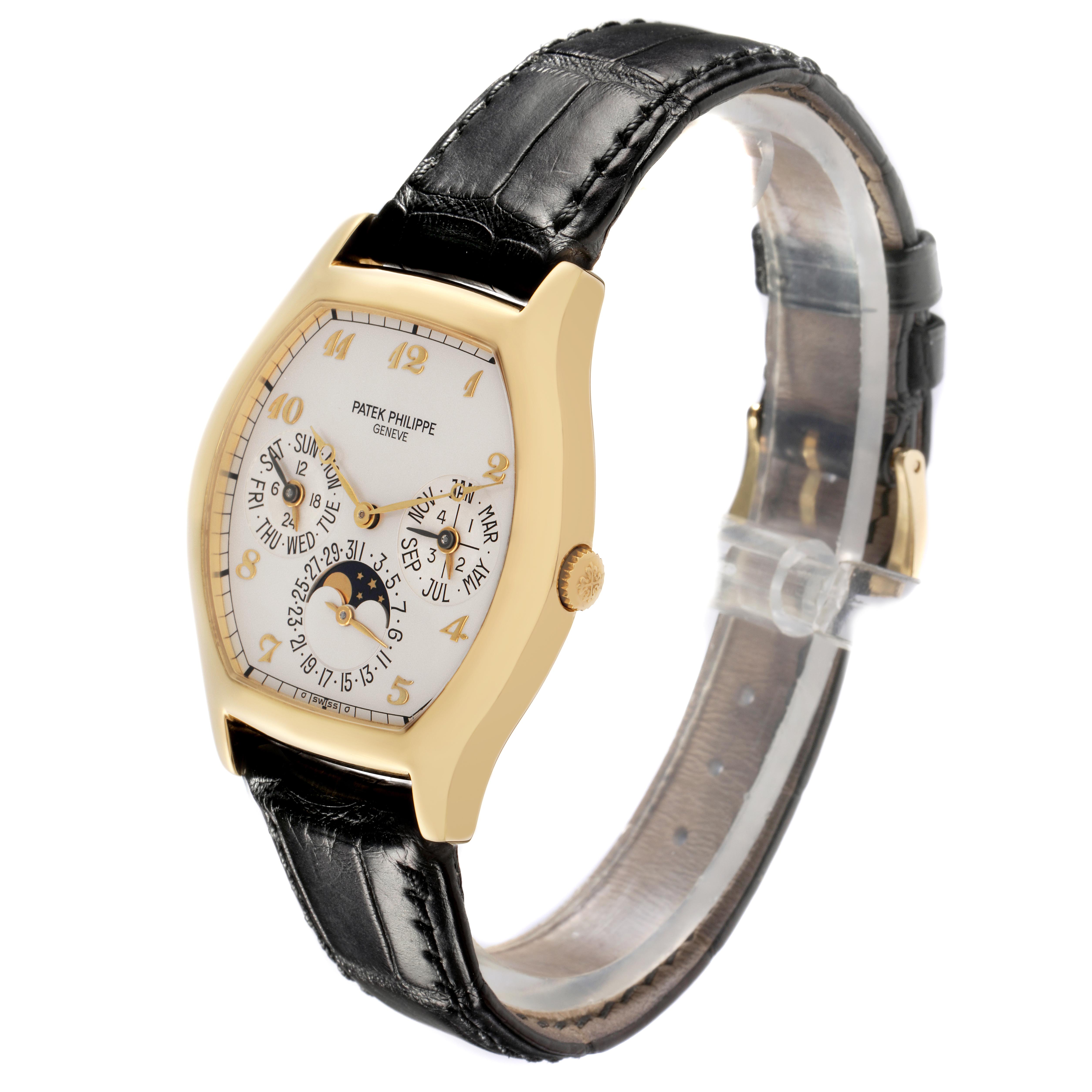The Patek Philippe Complications 5040J Men
s Yellow Gold Silver Dial 5040J Men
s Yellow Gold Silver Dial watch is shown at a three-quarter angle with focus on its face, case, and leather strap.