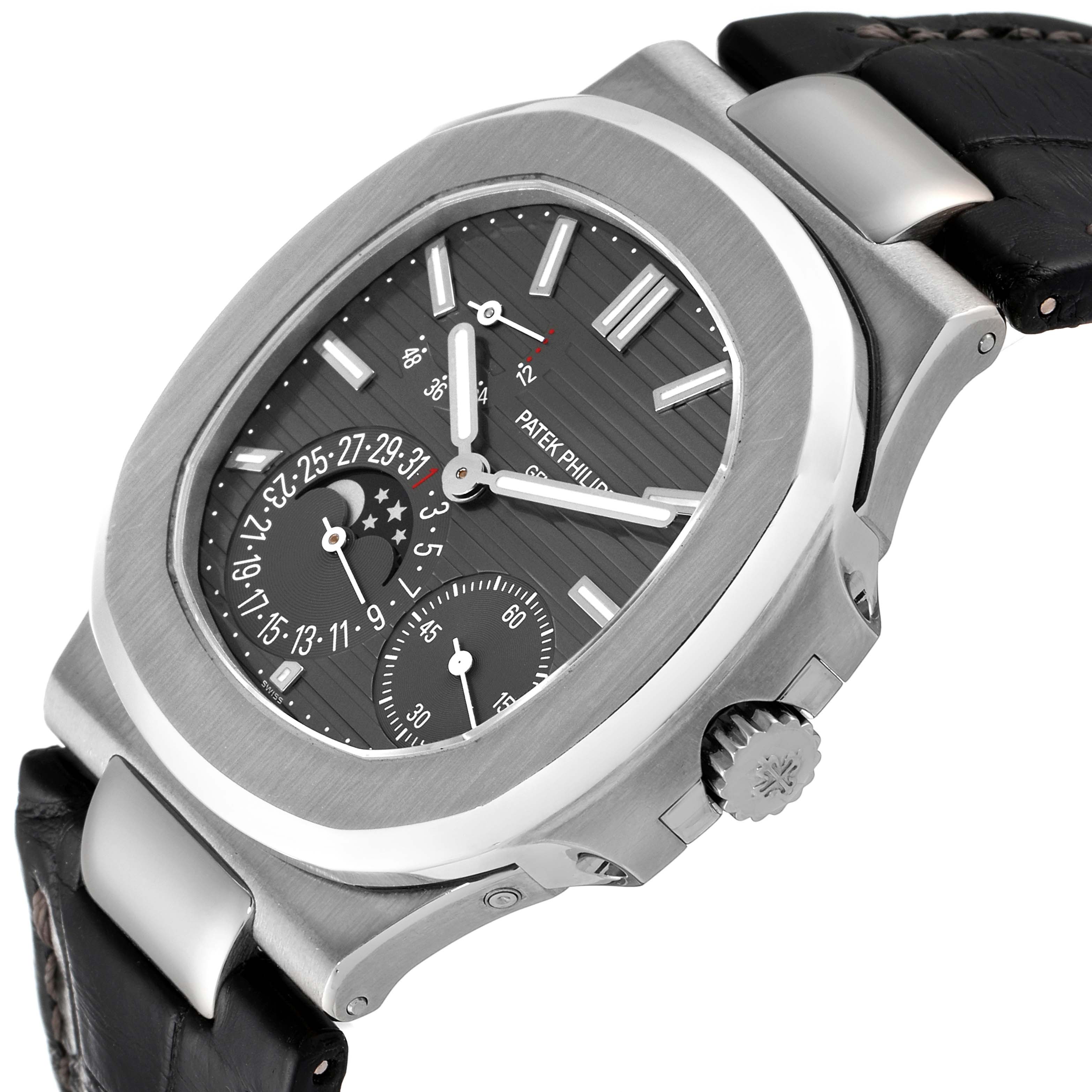 The image shows the Patek Philippe Nautilus 5712G/001 Men
s White Gold Grey Dial 5712G/001 Men
s White Gold Grey Dial watch from a slightly tilted side angle, displaying the case, crown, dial, and leather strap.