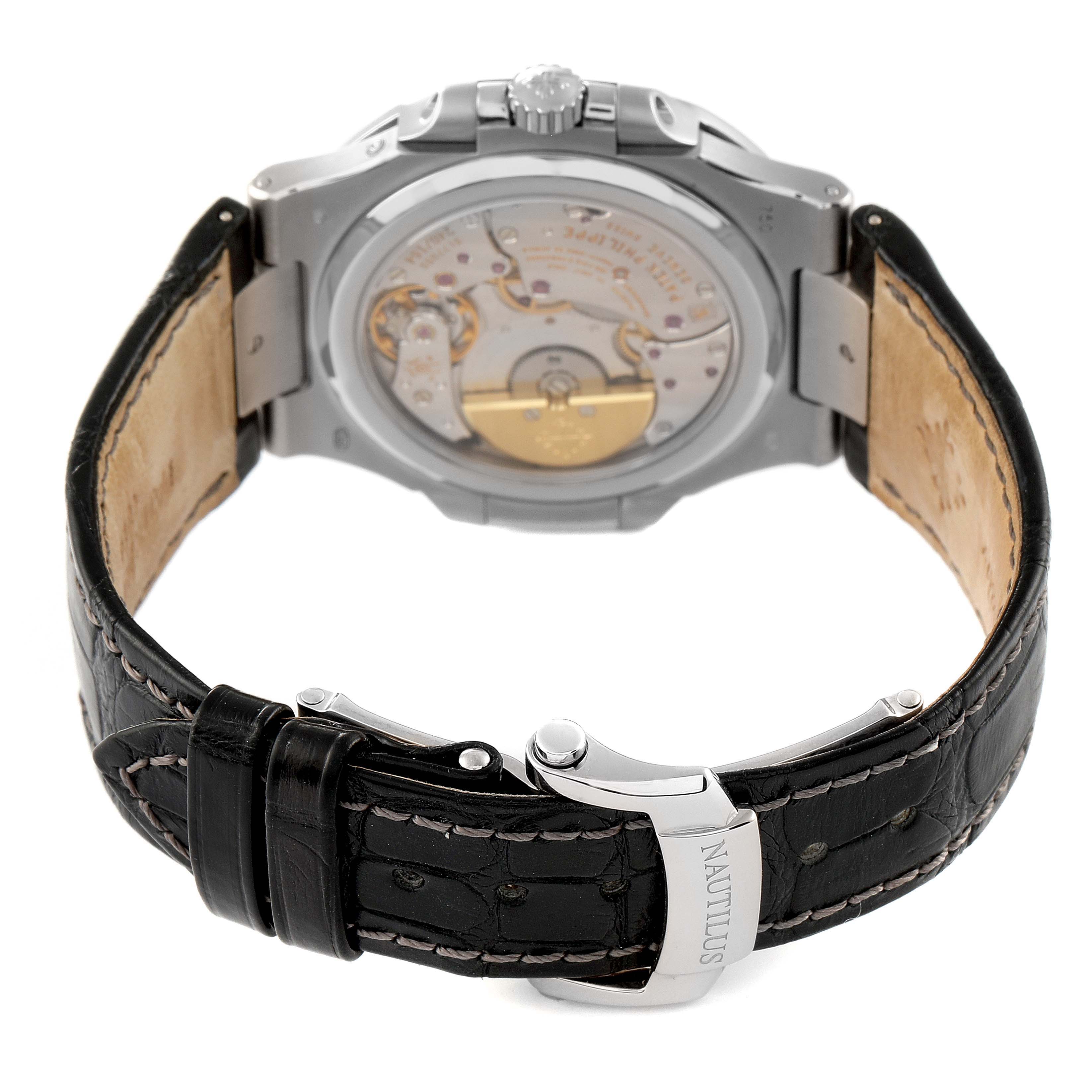 The image shows the back view of a Patek Philippe Nautilus 5712G/001 Men
s White Gold Grey Dial 5712G/001 Men
s White Gold Grey Dial watch, highlighting its open case back and leather strap with the engraved clasp.