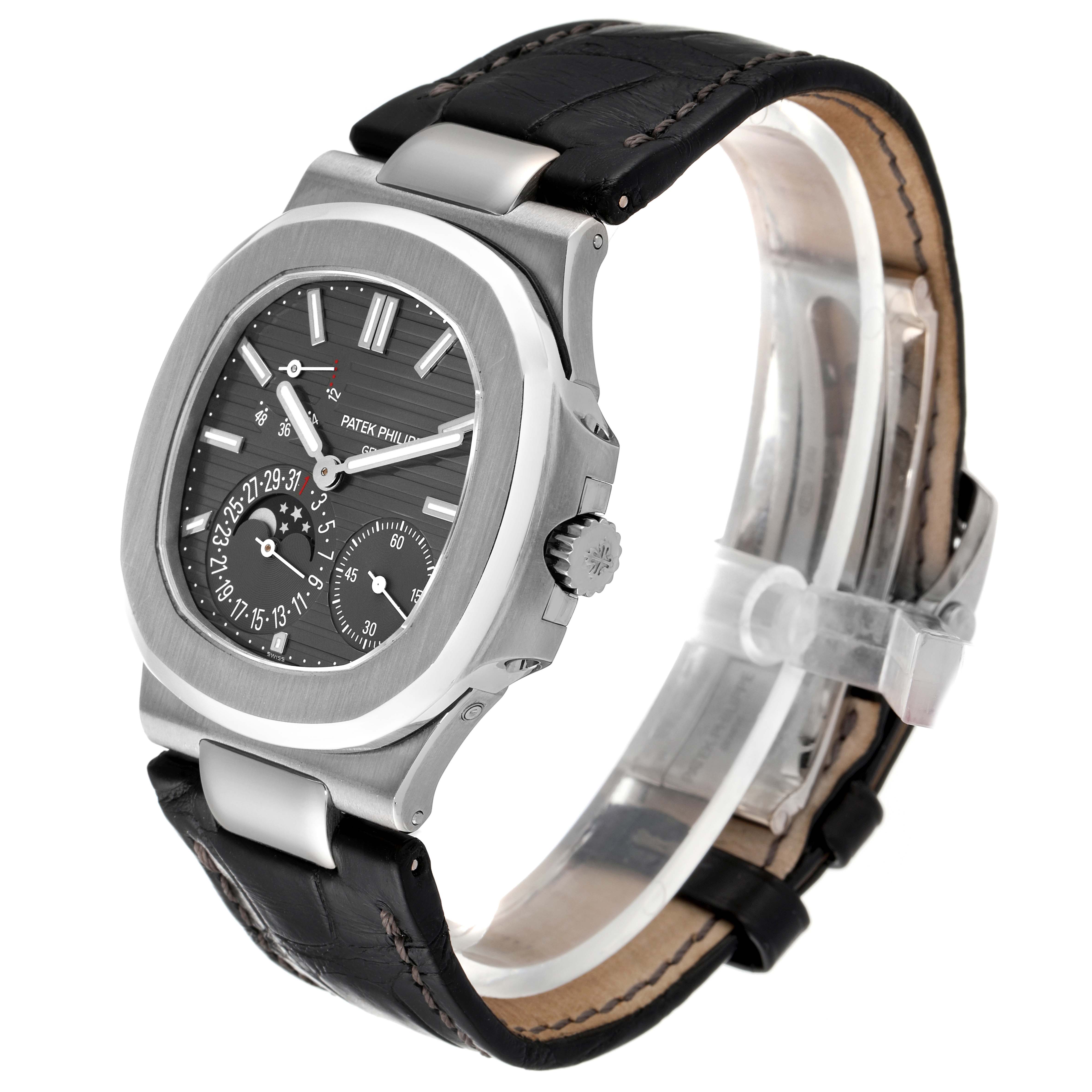 The image shows a Patek Philippe Nautilus 5712G/001 Men
s White Gold Grey Dial 5712G/001 Men
s White Gold Grey Dial watch from a three-quarter angle, highlighting its face, dials, crown, and leather strap.