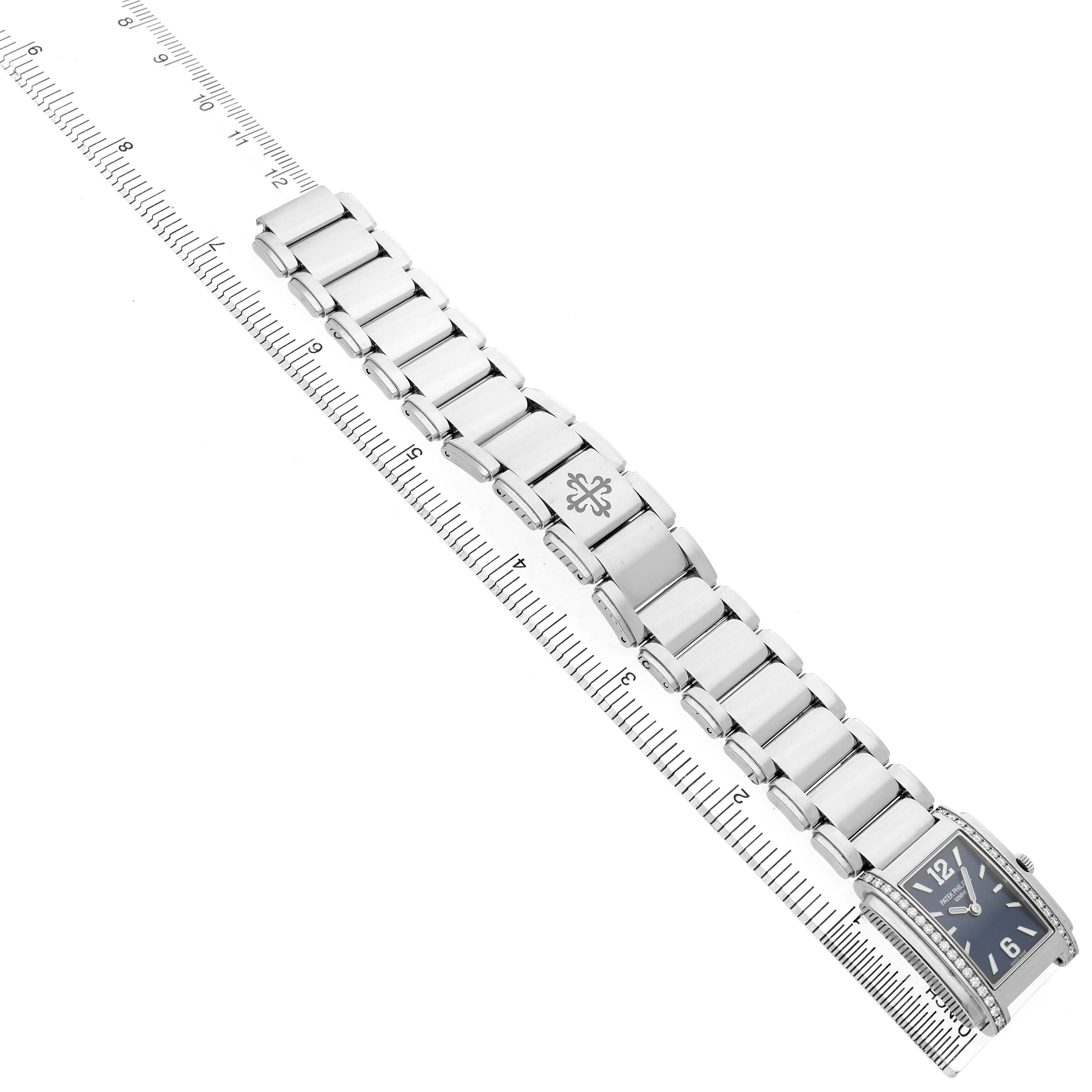 The Patek Philippe Twenty-4 4910 Women's Stainless Steel Blue Dial watch is shown from an overhead angle, displaying its face, bracelet, and deployment clasp.