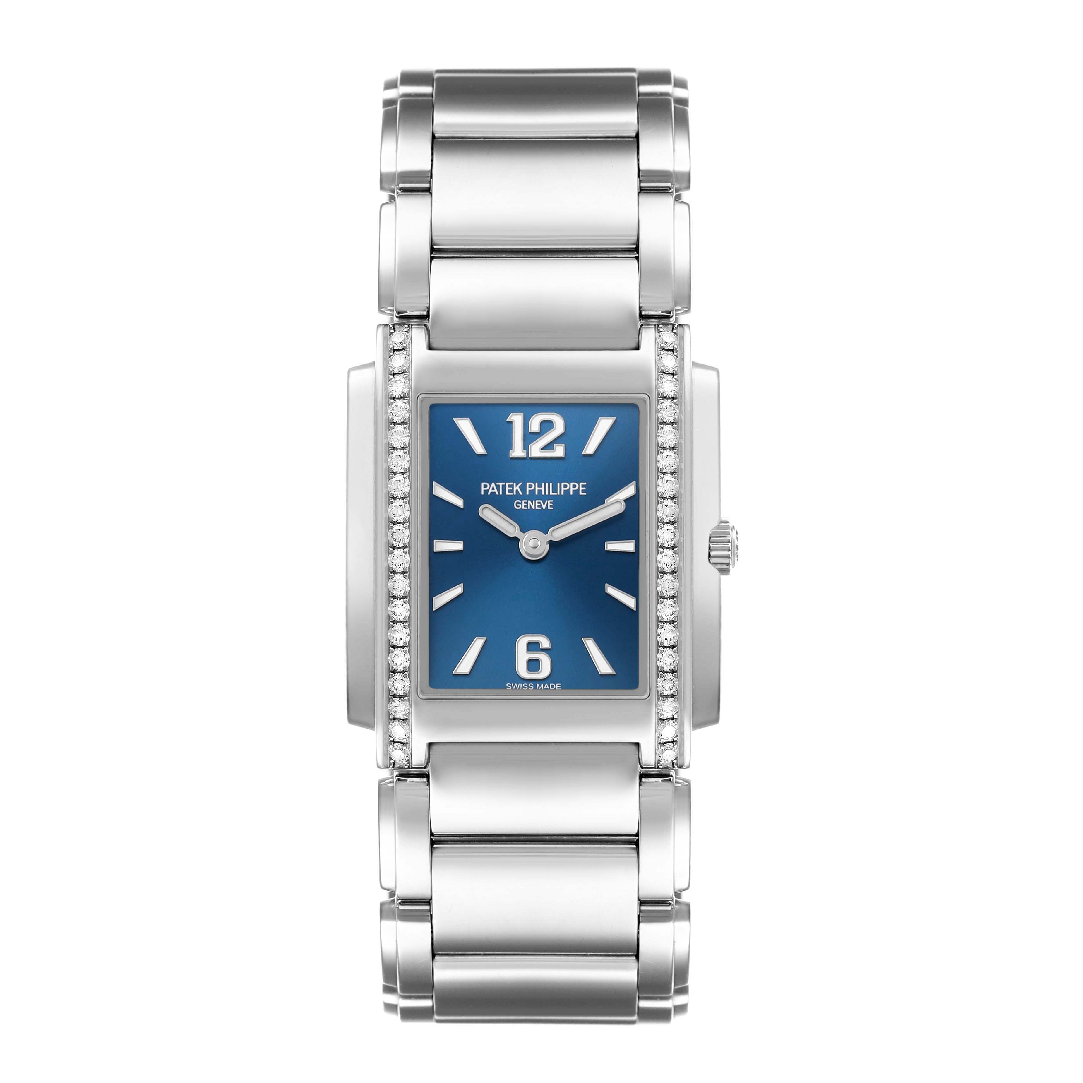 The Patek Philippe Twenty-4 4910 Women's Stainless Steel Blue Dial watch is shown from a top-down angle, displaying its blue dial, diamond-set bezel, and metal bracelet.