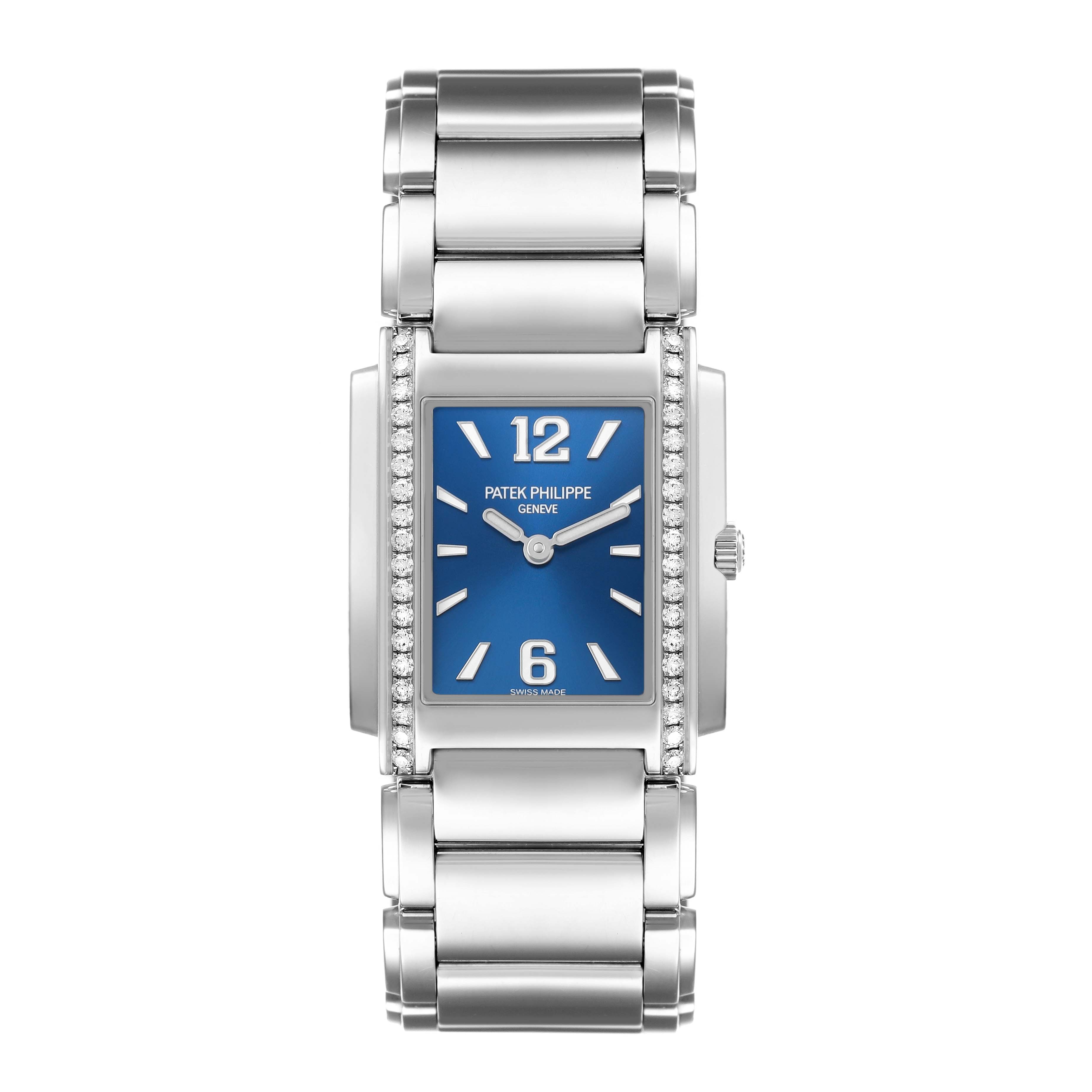 The Patek Philippe Twenty-4 4910 Women's Stainless Steel Blue Dial watch is shown from a top-down angle, highlighting its blue dial, diamond-set bezel, and metal bracelet.