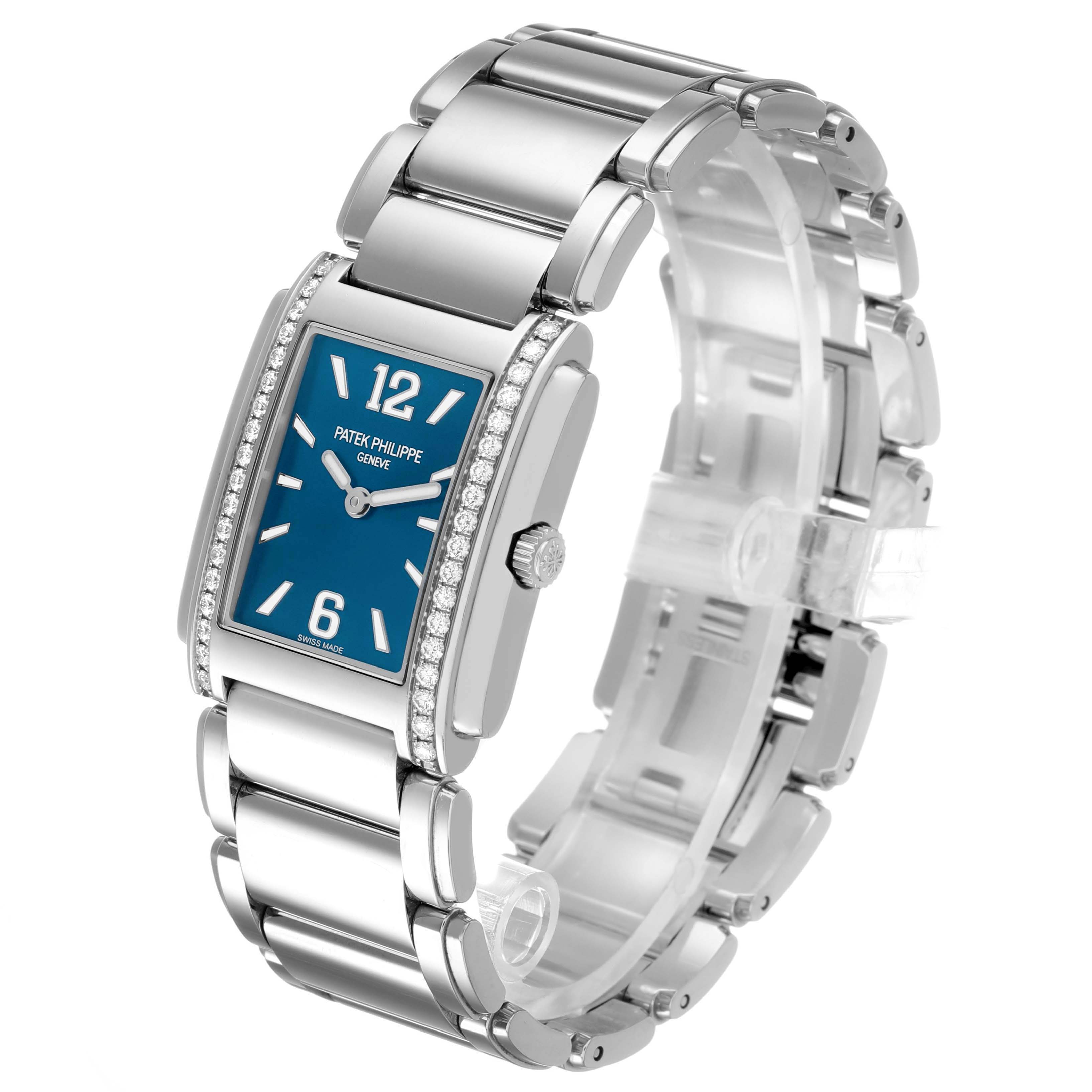 The Patek Philippe Twenty-4 4910 Women's Stainless Steel Blue Dial watch is shown in a three-quarter view, highlighting its blue dial, diamond-set bezel, and metallic bracelet.