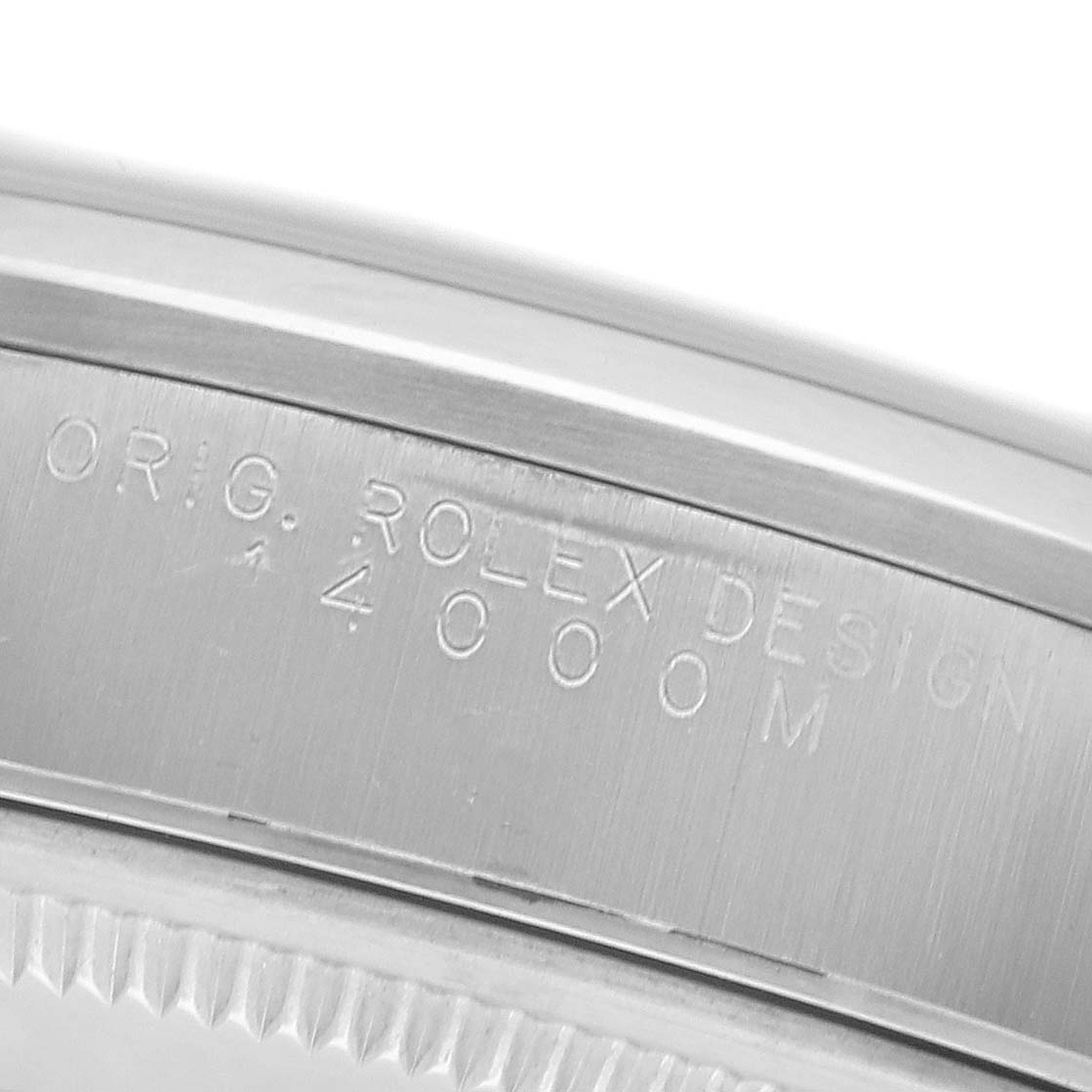 The image shows a close-up of the Rolex Air-King 14000M Men's Stainless Steel Blue Dial 14000M Men's Stainless Steel Blue Dial model's inner bezel with engraved text.