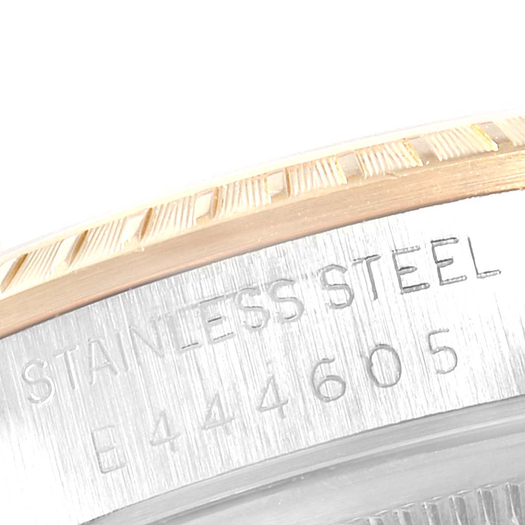 This image shows a close-up of the bezel and case sides of the Rolex Date 15223 Men's Steel and Gold (two tone) White Dial 15223 Men's Steel and Gold (two tone) White Dial model watch, highlighting the stainless steel inscription.