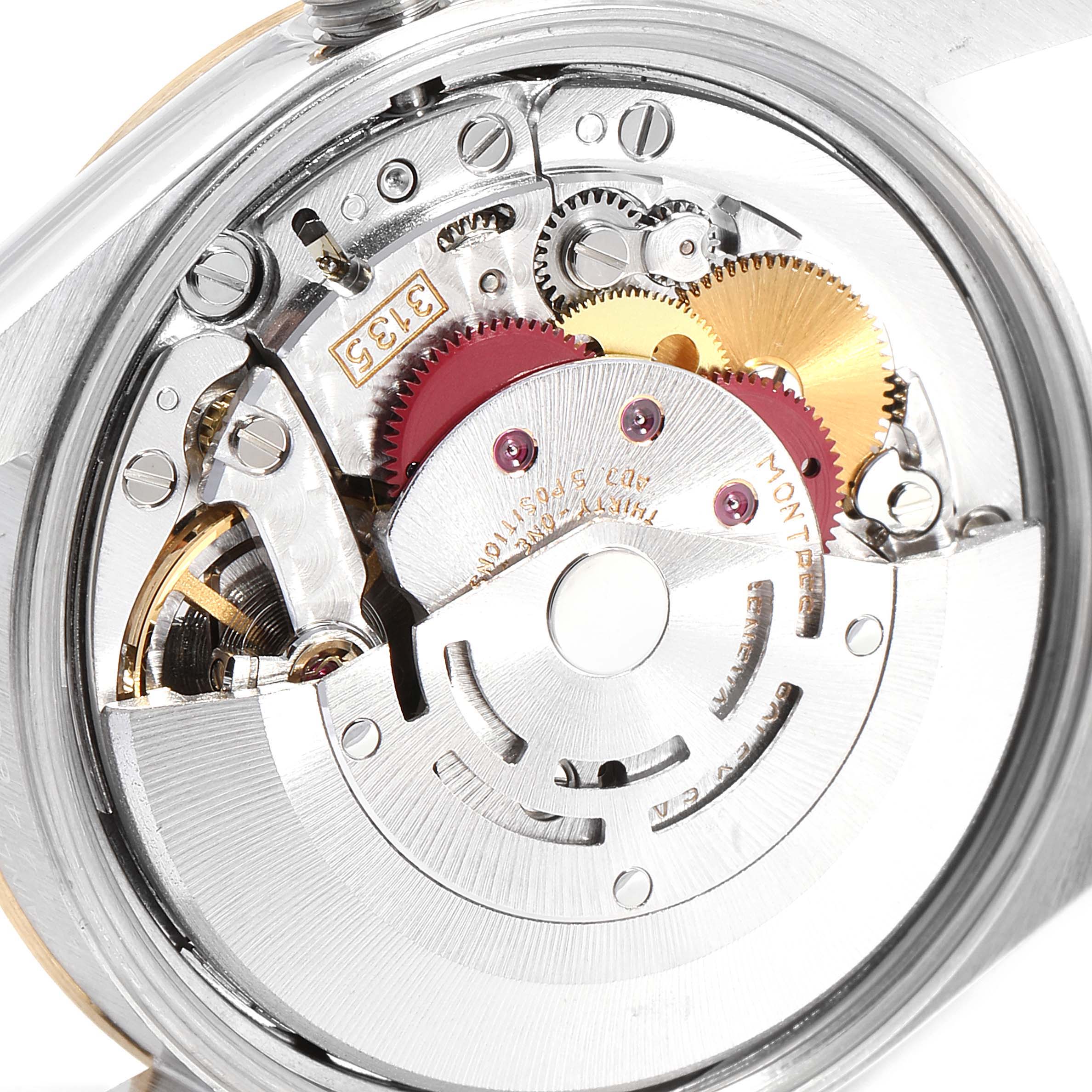 The image shows the inner mechanism of a Rolex Date 15223 Men's Steel and Gold (two tone) White Dial 15223 Men's Steel and Gold (two tone) White Dial watch, highlighting gears, rotors, and other mechanical parts.