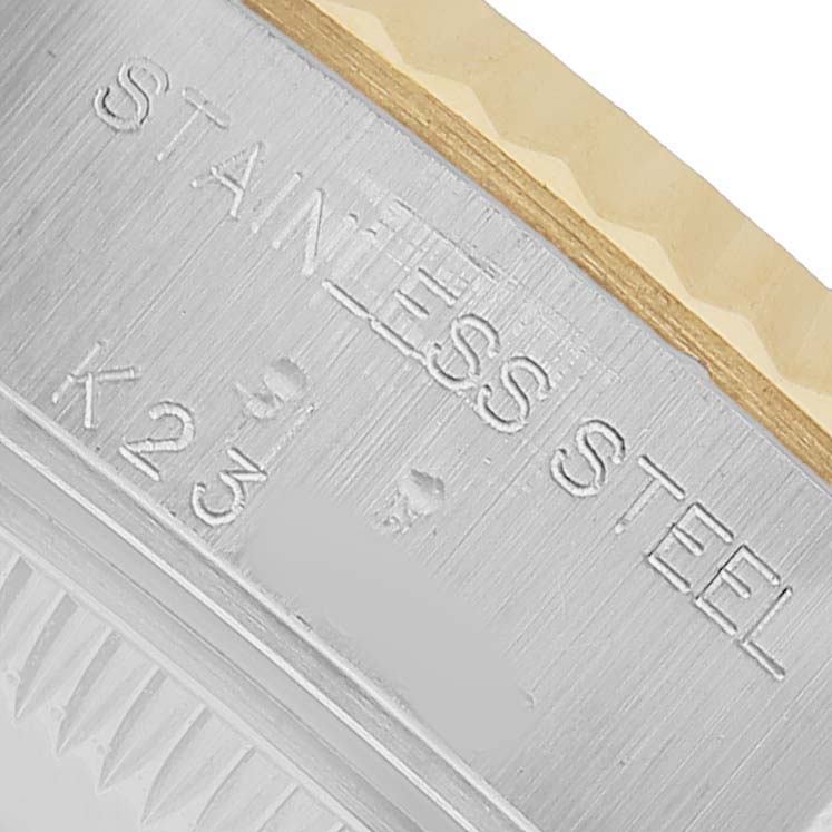 The image shows a close-up of the case back edge and bezel of a Rolex Datejust 79173 Women's Stainless Steel White Dial, highlighting "STAINLESS STEEL" engraving.