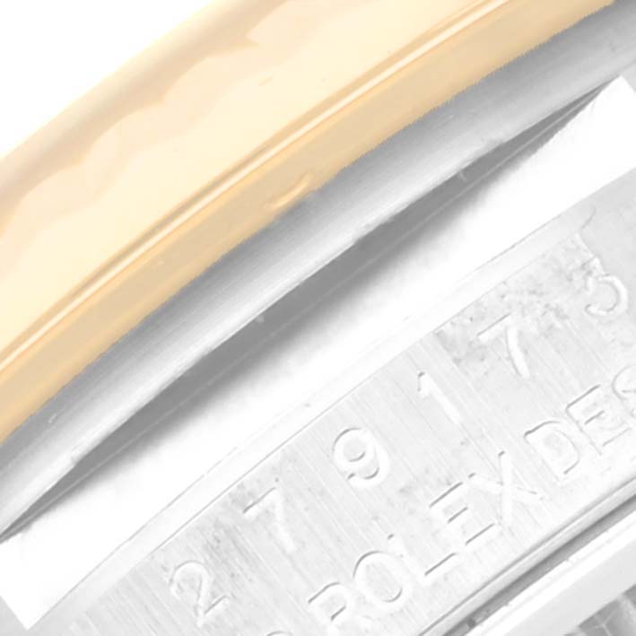 This close-up image of a Rolex Datejust 279173 Women's Steel and Gold (two tone) Silver Dial 279173 Women's Steel and Gold (two tone) Silver Dial focuses on the case band, showcasing the model number engraving and a portion of the bezel.