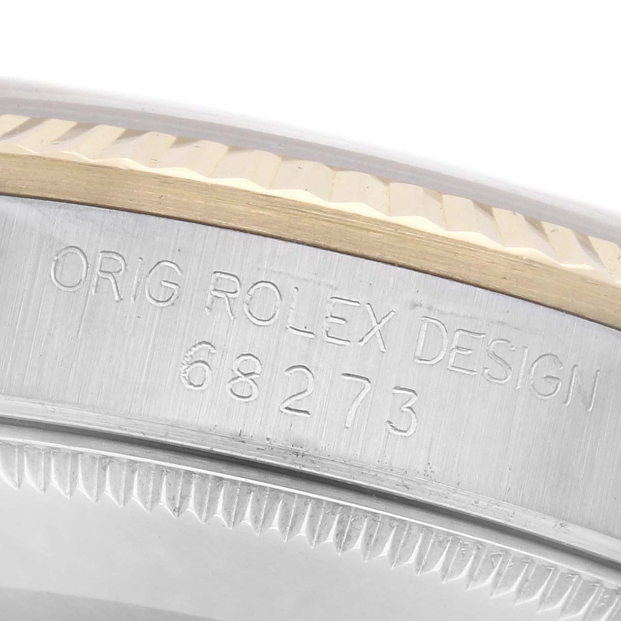 The image shows a close-up of the side of a Rolex Mid-Size 68273 Women
s Steel and Gold (two tone) Champagne Dial 68273 Women
s Steel and Gold (two tone) Champagne Dial watch, highlighting the engraved model number and design text.