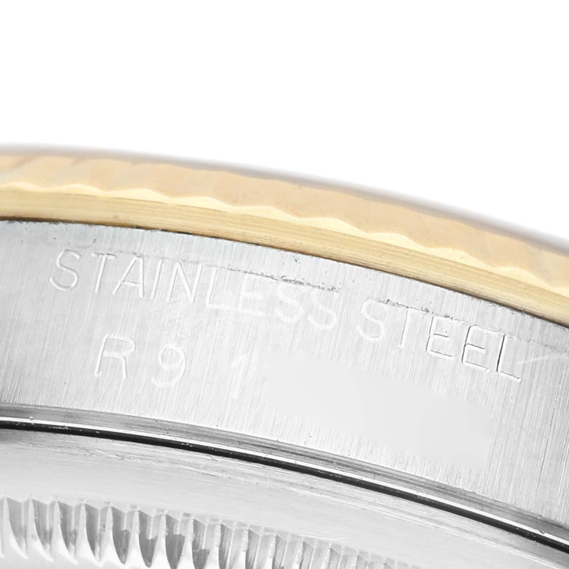 The image shows a close-up of the side of a Rolex Datejust 16233 Men's Stainless Steel Silver Dial, highlighting the stainless steel part with engraved text.