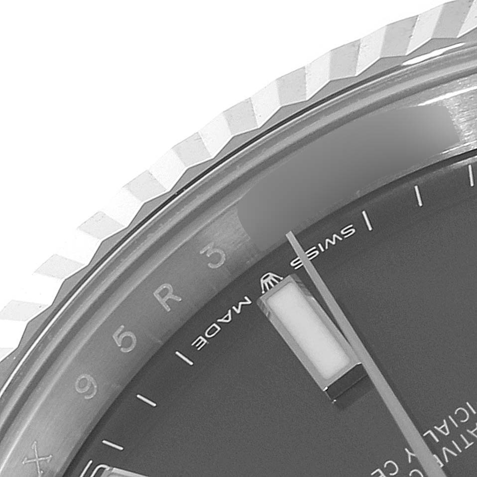 The image shows a close-up of the Rolex Datejust 41 126334 Men's Stainless Steel Grey Dial 126334 Men's Stainless Steel Grey Dial's bezel, part of the dial, and indices, viewed from an oblique angle.