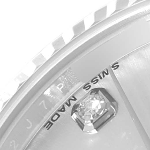 This image shows a close-up of the dial, bezel, and a diamond marker of a Mid-Size Rolex watch.