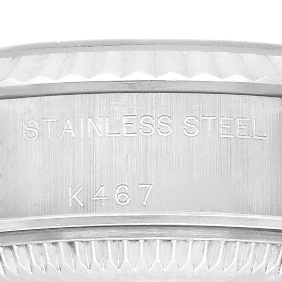 The image shows a close-up of the side of a Rolex Datejust 79174 Women's Stainless Steel Mother of Pearl Dial 79174 Women's Stainless Steel Mother of Pearl Dial watch with "STAINLESS STEEL" and a partial serial number visible.