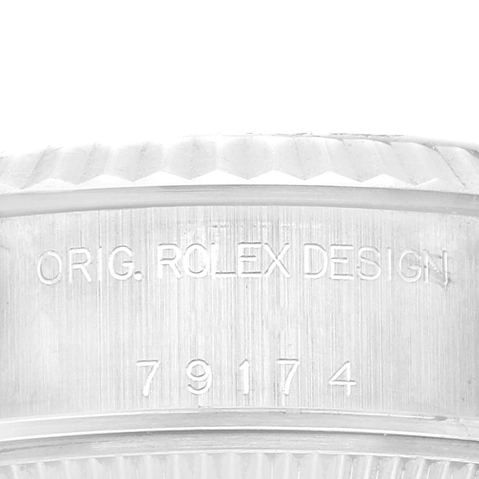 The image shows an up-close view of the side engraving on a Rolex Datejust 79174 Women's Stainless Steel Mother of Pearl Dial 79174 Women's Stainless Steel Mother of Pearl Dial watch, displaying "ORIG. ROLEX DESIGN" and the serial number.