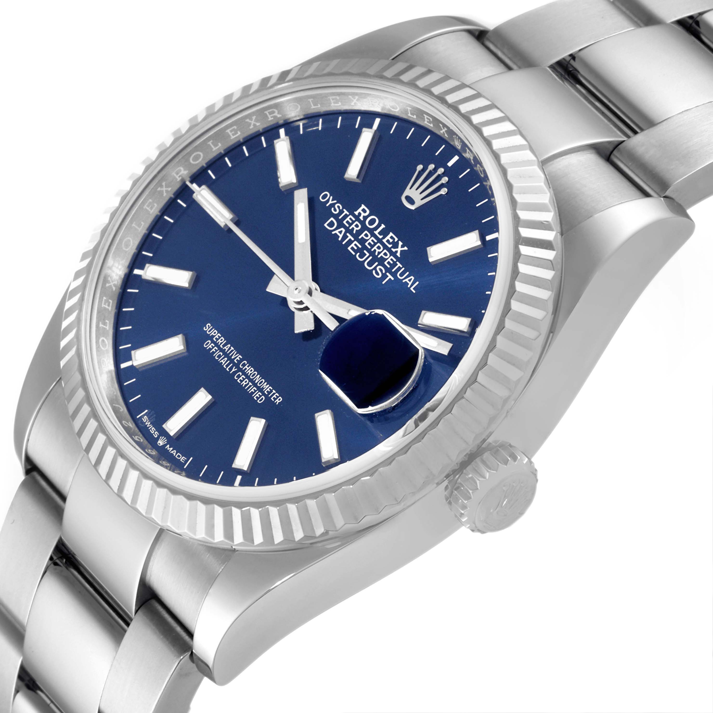 The Rolex Datejust 126234 Men's Stainless Steel Blue Dial 126234 Men's Stainless Steel Blue Dial watch is shown at an angled close-up, displaying the dial, bezel, and part of the bracelet.