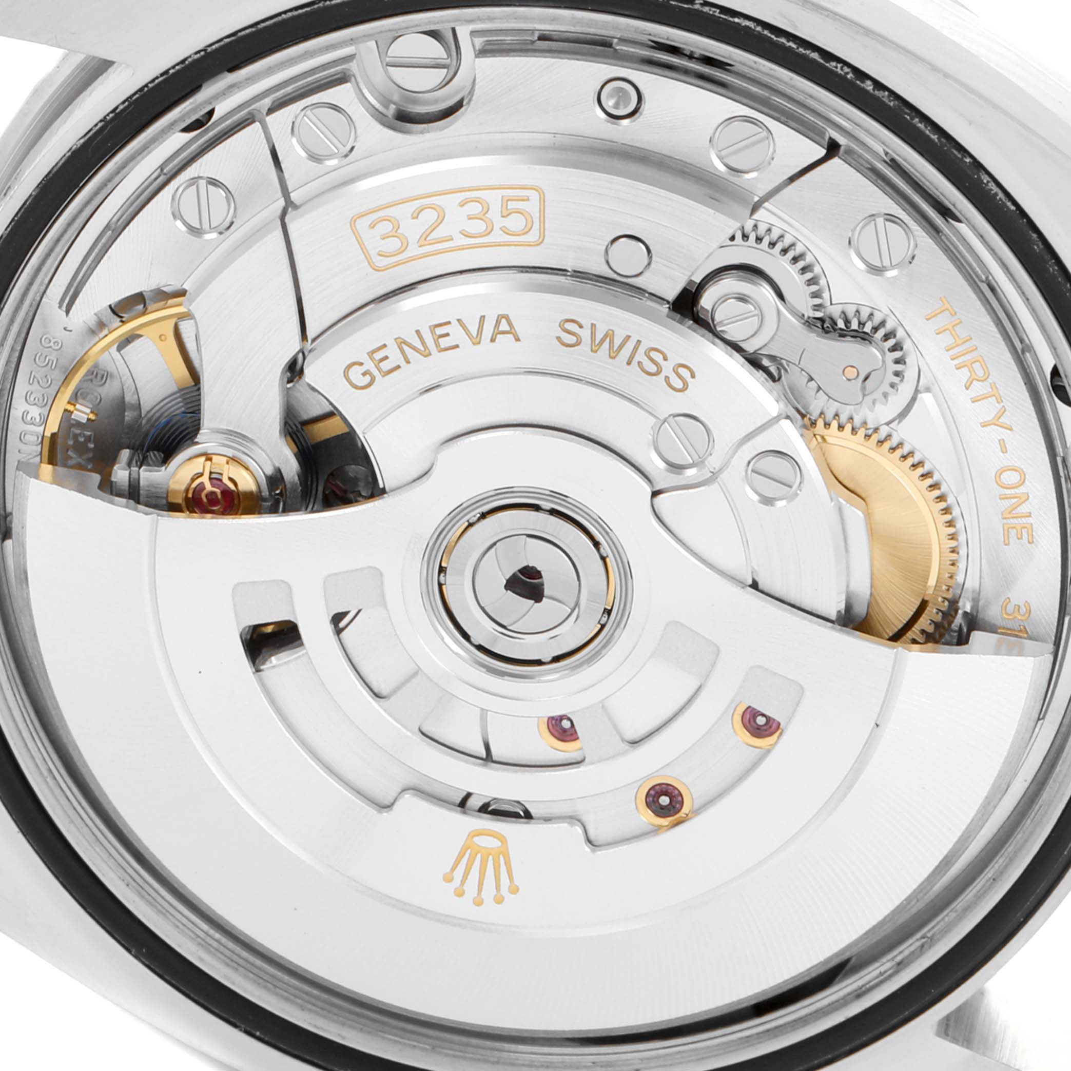 The image shows a close-up view of the Rolex Datejust 126234 Men's Stainless Steel Blue Dial 126234 Men's Stainless Steel Blue Dial's movement, specifically the calibre 3235, with parts such as gears and the rotor visible.