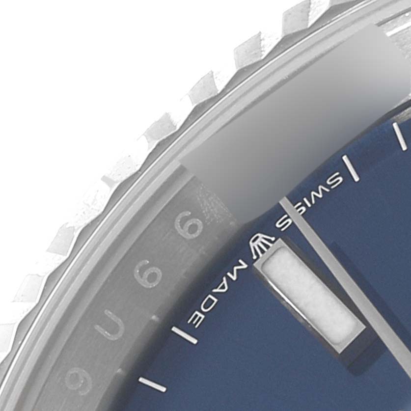 The image shows a close-up view of the bezel, dial, and part of the hour hand of a Rolex Datejust 126234 Men's Stainless Steel Blue Dial 126234 Men's Stainless Steel Blue Dial watch.