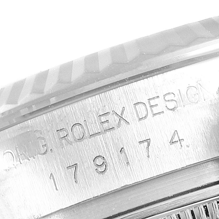 This close-up image of a Rolex Datejust 179174 Women's Stainless Steel Silver Dial 179174 Women's Stainless Steel Silver Dial model watch shows the engraved text on the side of the case.