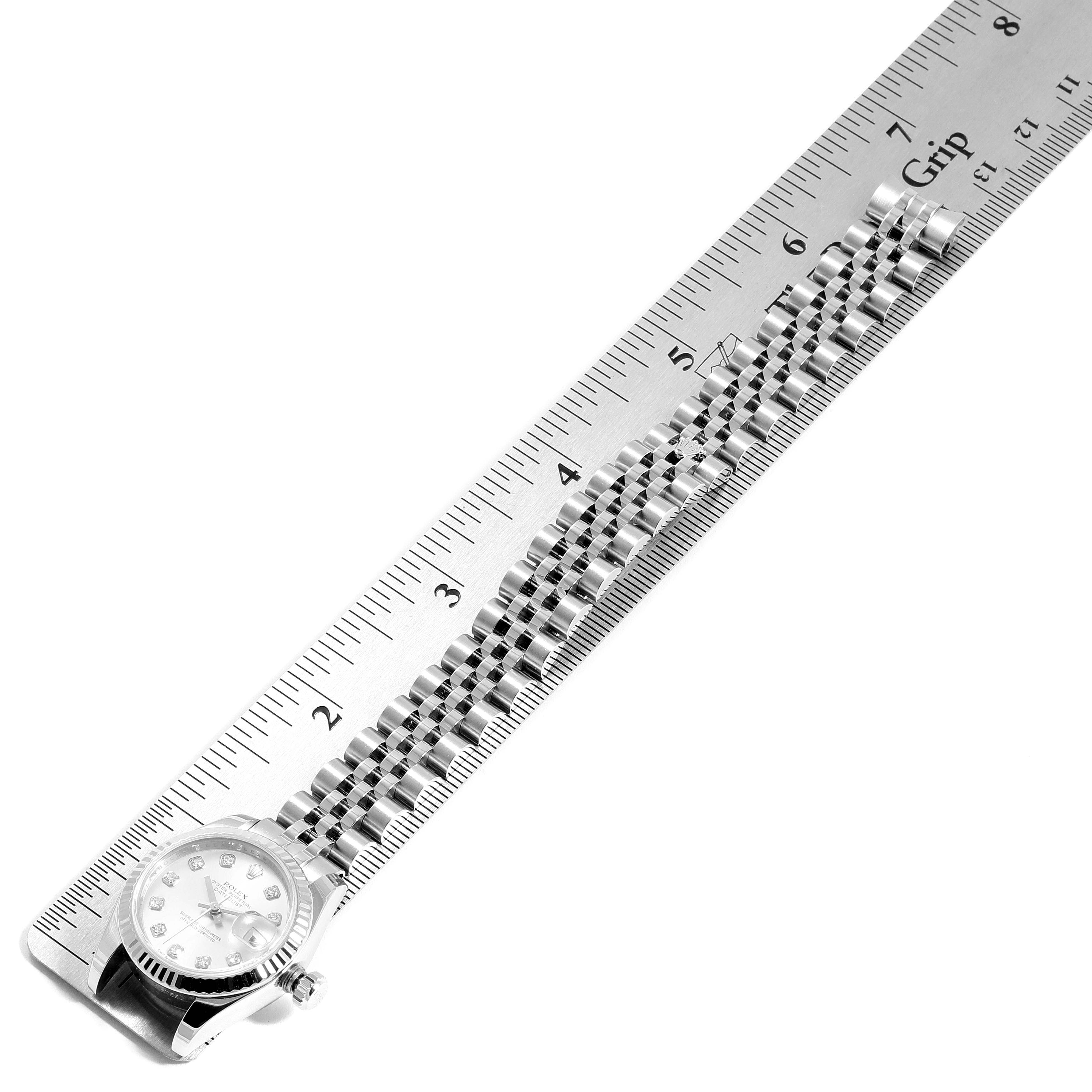 The image shows a Rolex Datejust 179174 Women's Stainless Steel Silver Dial 179174 Women's Stainless Steel Silver Dial watch laying flat with a focus on its face and bracelet next to a ruler for size measurement.