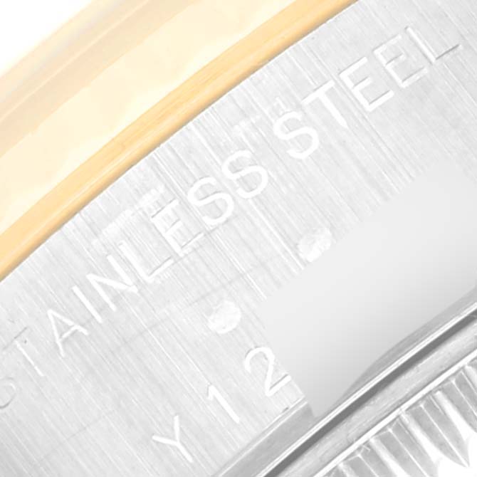 This close-up image of a Rolex Datejust 79173 Women's Steel and Gold (two tone) Black Dial 79173 Women's Steel and Gold (two tone) Black Dial watch shows part of the stainless steel caseback and some engravings.