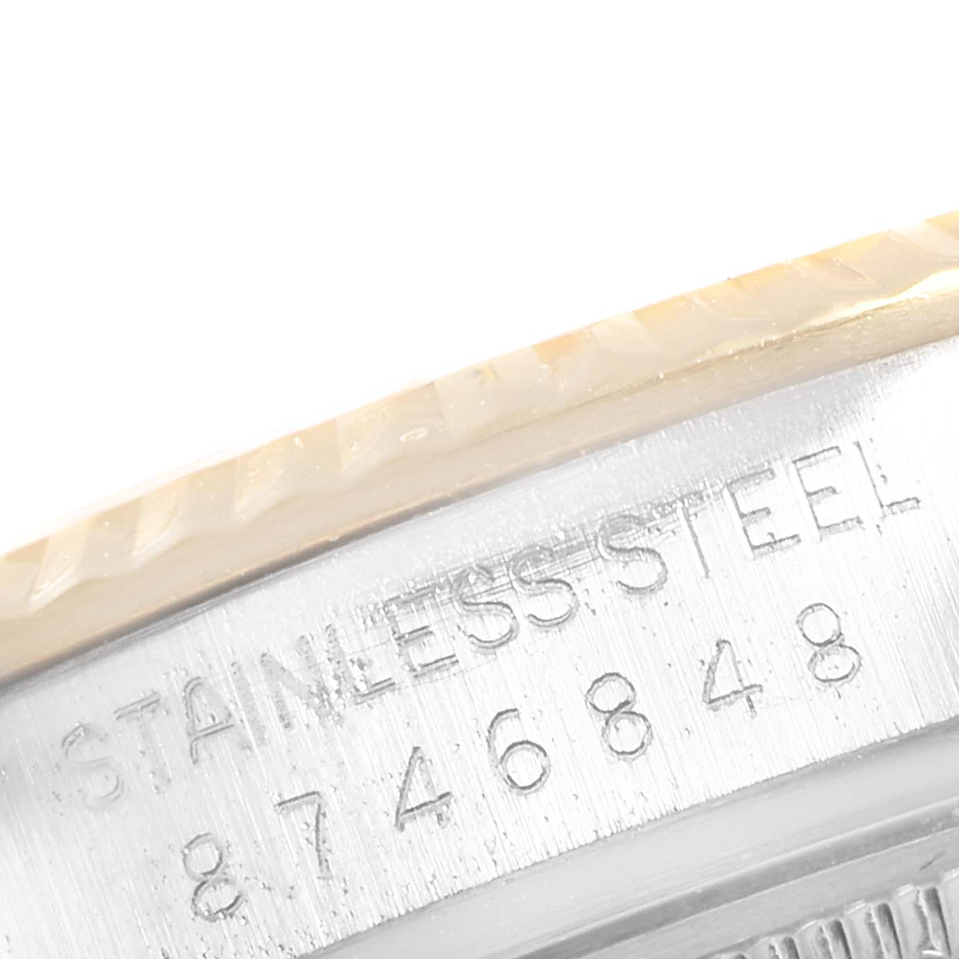 The image shows a close-up of the etched serial numbers on the case side of a Rolex Datejust 27465 Men
s Steel and Gold (two tone) Black Dial 27465 Men
s Steel and Gold (two tone) Black Dial watch.