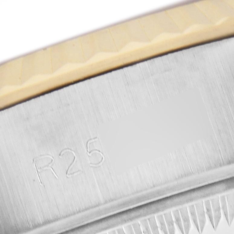 The image shows a close-up of the Rolex Datejust 69173 Women
s Steel and Gold (two tone) Champagne Dial 69173 Women
s Steel and Gold (two tone) Champagne Dial bezel with part of the engravings visible.