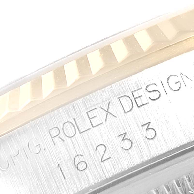 This close-up image shows the bezel and part of the engraved case side of a Rolex Datejust 16233 Men's Steel and Gold (two tone) Blue Dial 16233 Men's Steel and Gold (two tone) Blue Dial model.