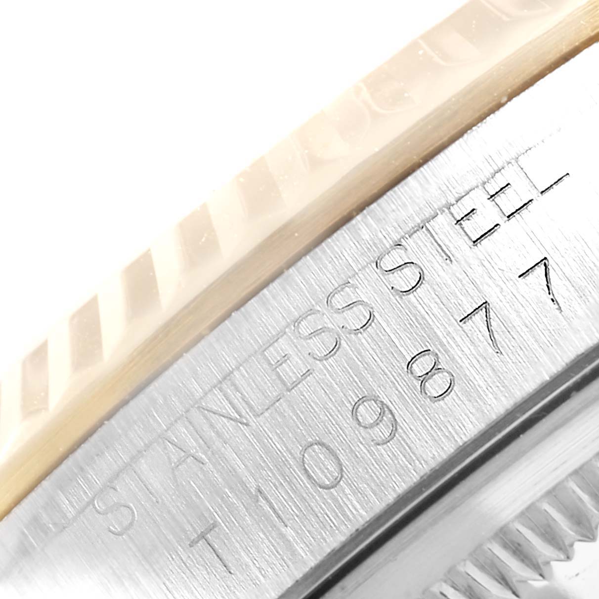 This image shows a close-up of the serial number and "STAINLESS STEEL" engraving on the case side of a Rolex Datejust 16233 Men's Steel and Gold (two tone) Blue Dial 16233 Men's Steel and Gold (two tone) Blue Dial watch.