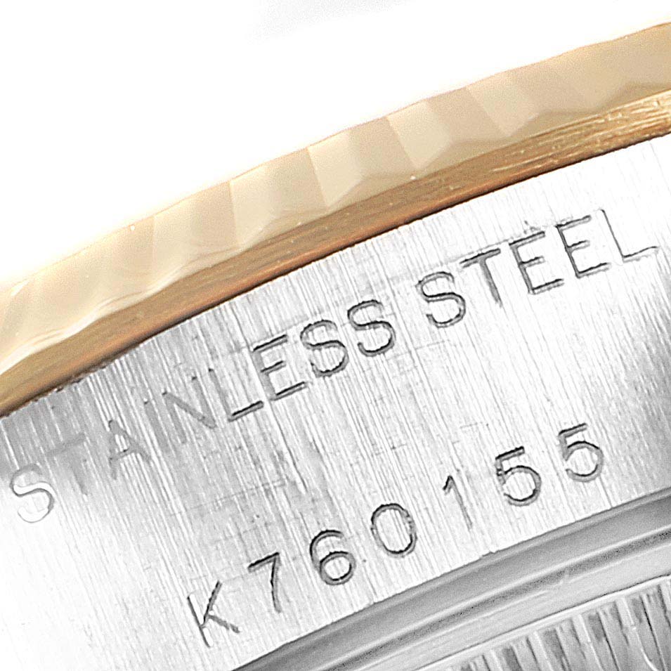 This image shows a close-up of the serial number and "STAINLESS STEEL" engraving on the Rolex Datejust 79173 Women
s Steel and Gold (two tone) Mother of Pearl Dial 79173 Women
s Steel and Gold (two tone) Mother of Pearl Dial watch.