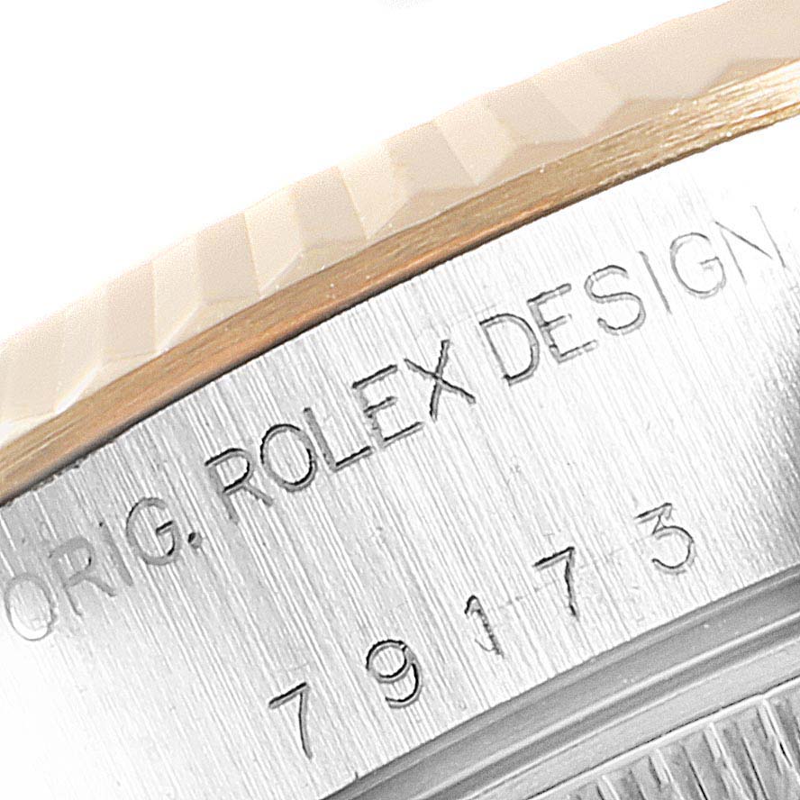 This close-up image shows the side of the bezel and etched serial number of a Rolex Datejust 79173 Women
s Steel and Gold (two tone) Mother of Pearl Dial 79173 Women
s Steel and Gold (two tone) Mother of Pearl Dial watch.