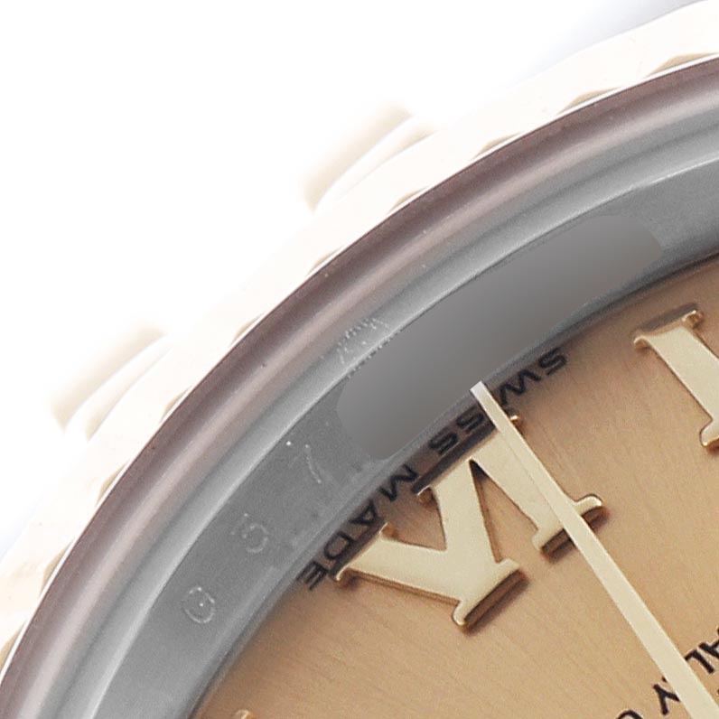 The image shows a close-up of the dial edge and bezel of a Rolex Datejust 179173 Women
s Steel and Gold (two tone) Champagne Dial 179173 Women
s Steel and Gold (two tone) Champagne Dial, highlighting Roman numerals and the "Swiss Made" inscription.