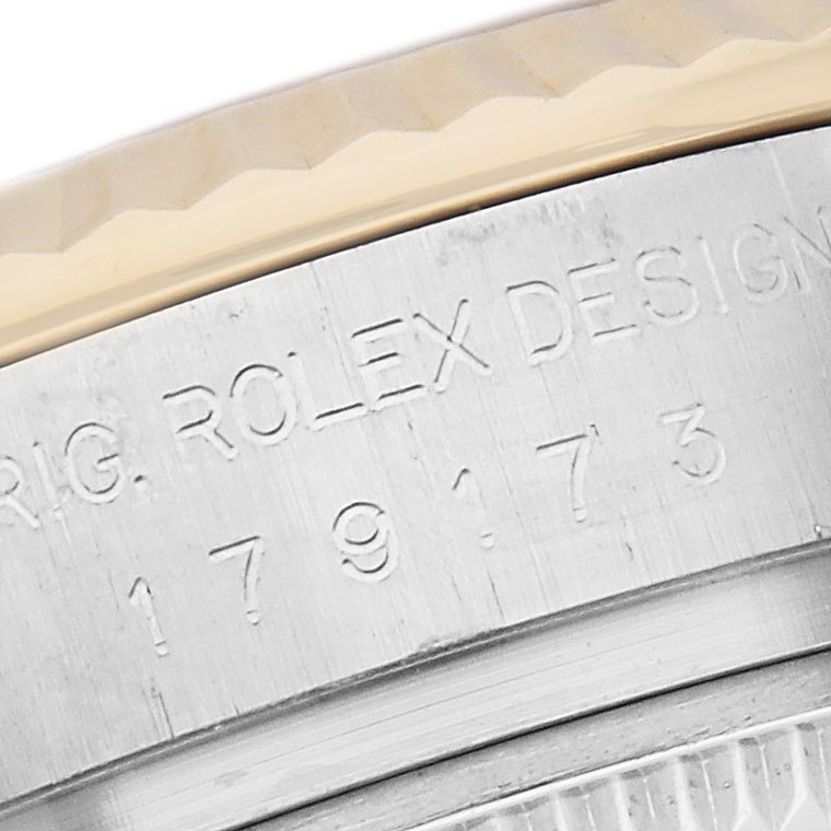 The image shows a close-up of the engraved side of a Rolex Datejust 179173 Women
s Steel and Gold (two tone) Champagne Dial 179173 Women
s Steel and Gold (two tone) Champagne Dial watch, highlighting the model number and design details.