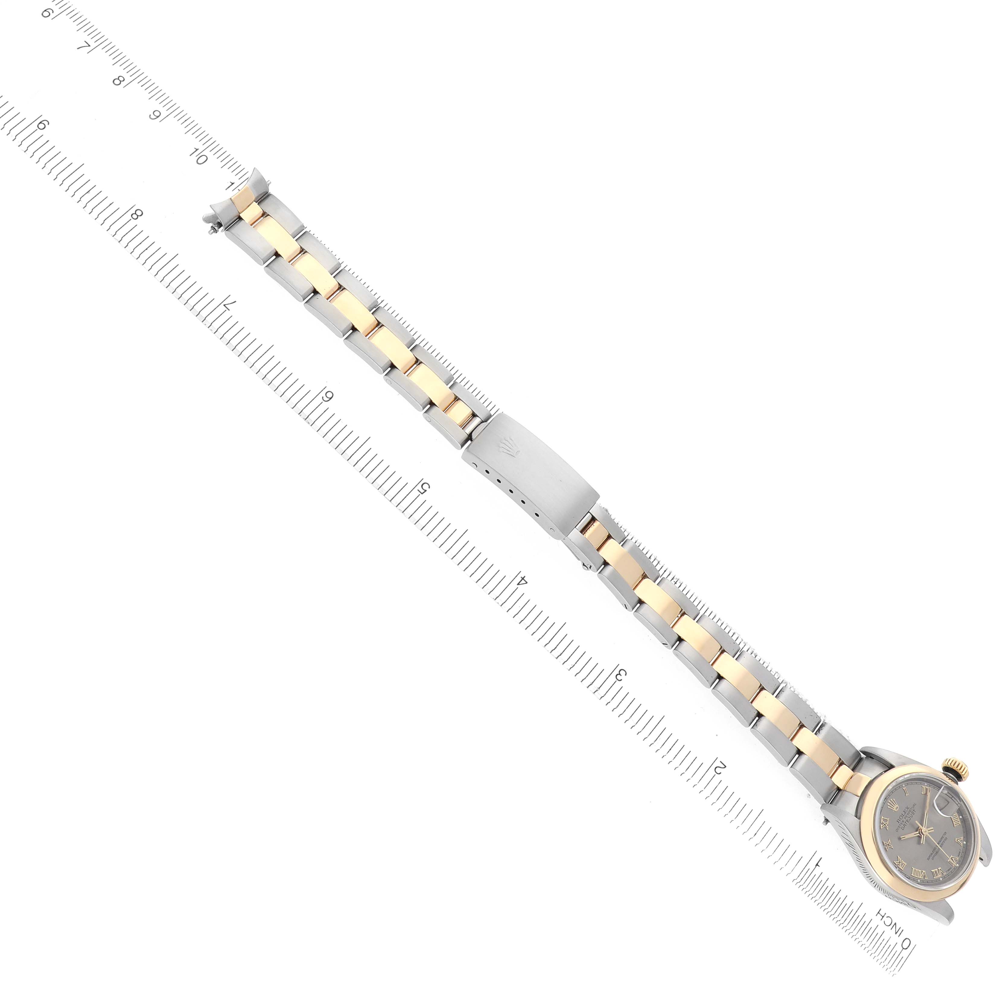 The Rolex Datejust 69163 Women
s Steel and Gold (two tone) Grey Dial 69163 Women
s Steel and Gold (two tone) Grey Dial watch is shown from an overhead angle, featuring the full band and watch face with a ruler for scale.