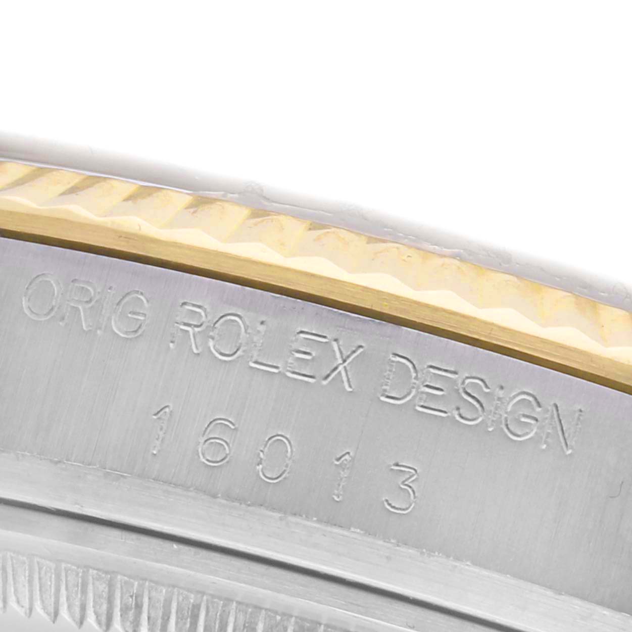 The image shows a close-up of the bezel and engraved case edge of a Rolex Datejust 16013 Men's Steel and Gold (two tone) Champagne Dial 16013 Men's Steel and Gold (two tone) Champagne Dial watch.