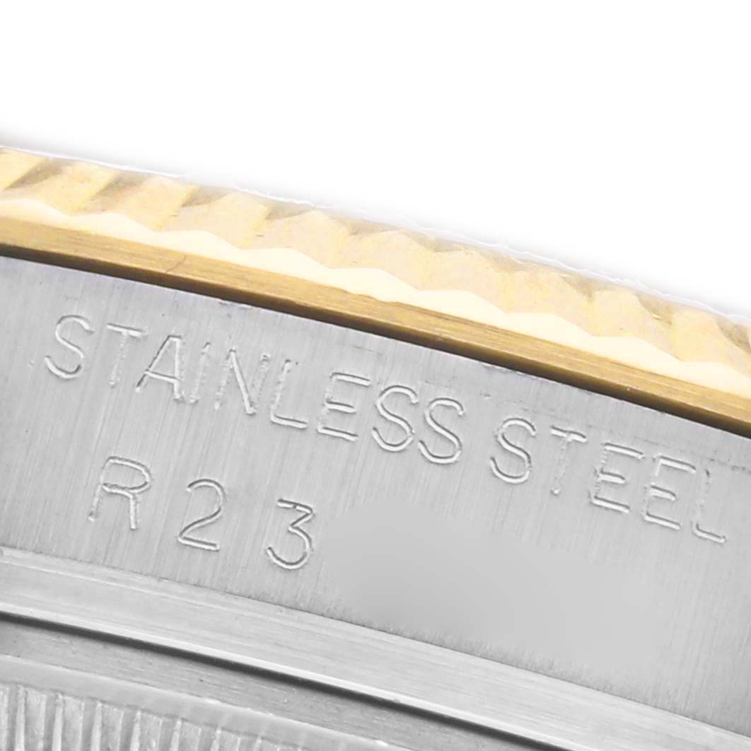 The image shows a close-up of the Rolex Datejust 16013 Men's Steel and Gold (two tone) Champagne Dial 16013 Men's Steel and Gold (two tone) Champagne Dial's case edge with "STAINLESS STEEL" engraved on it.