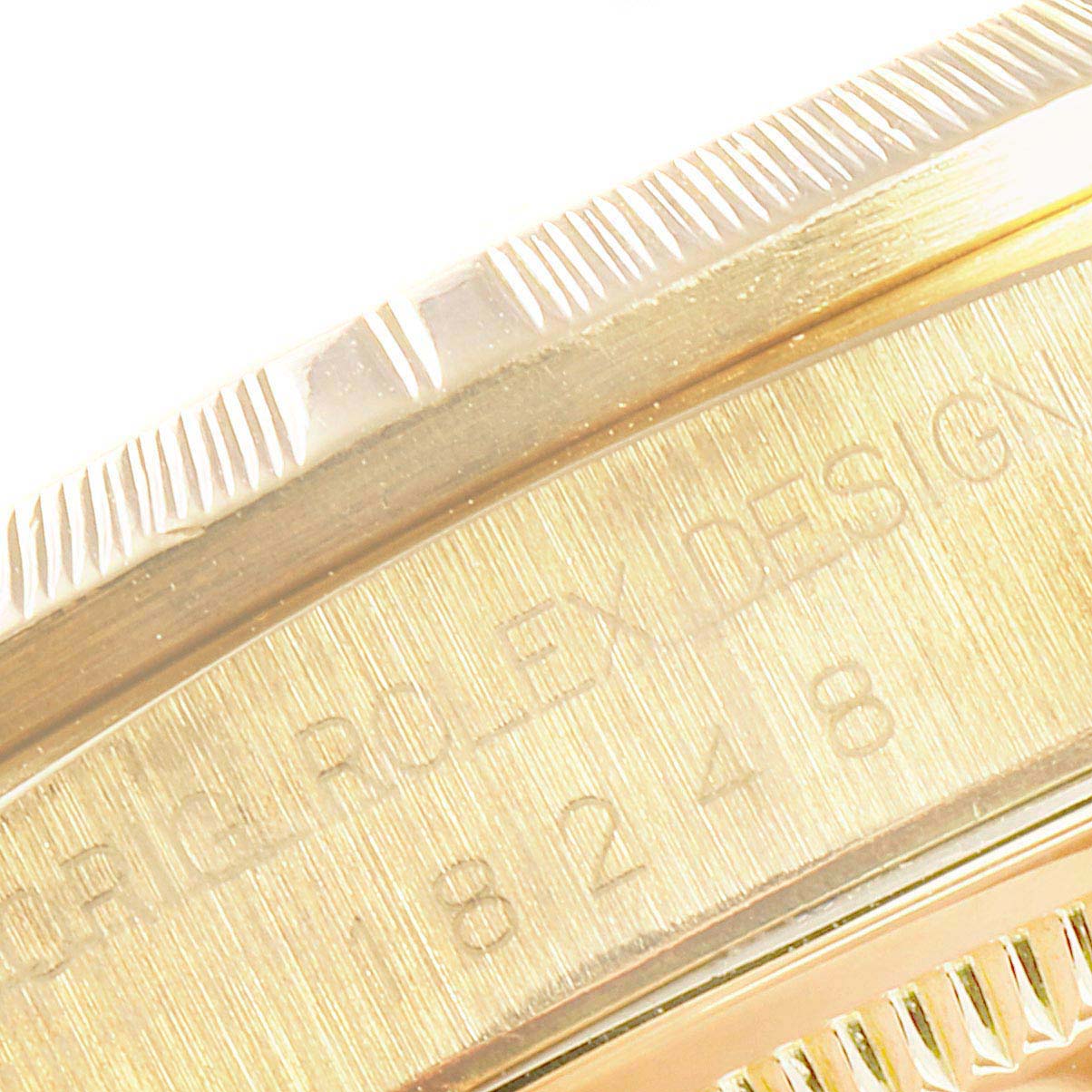 This is a close-up of the case side and bezel edge of a Rolex President 18248 Men
s Yellow Gold Champagne Dial 18248 Men
s Yellow Gold Champagne Dial model watch, showing engraved details.