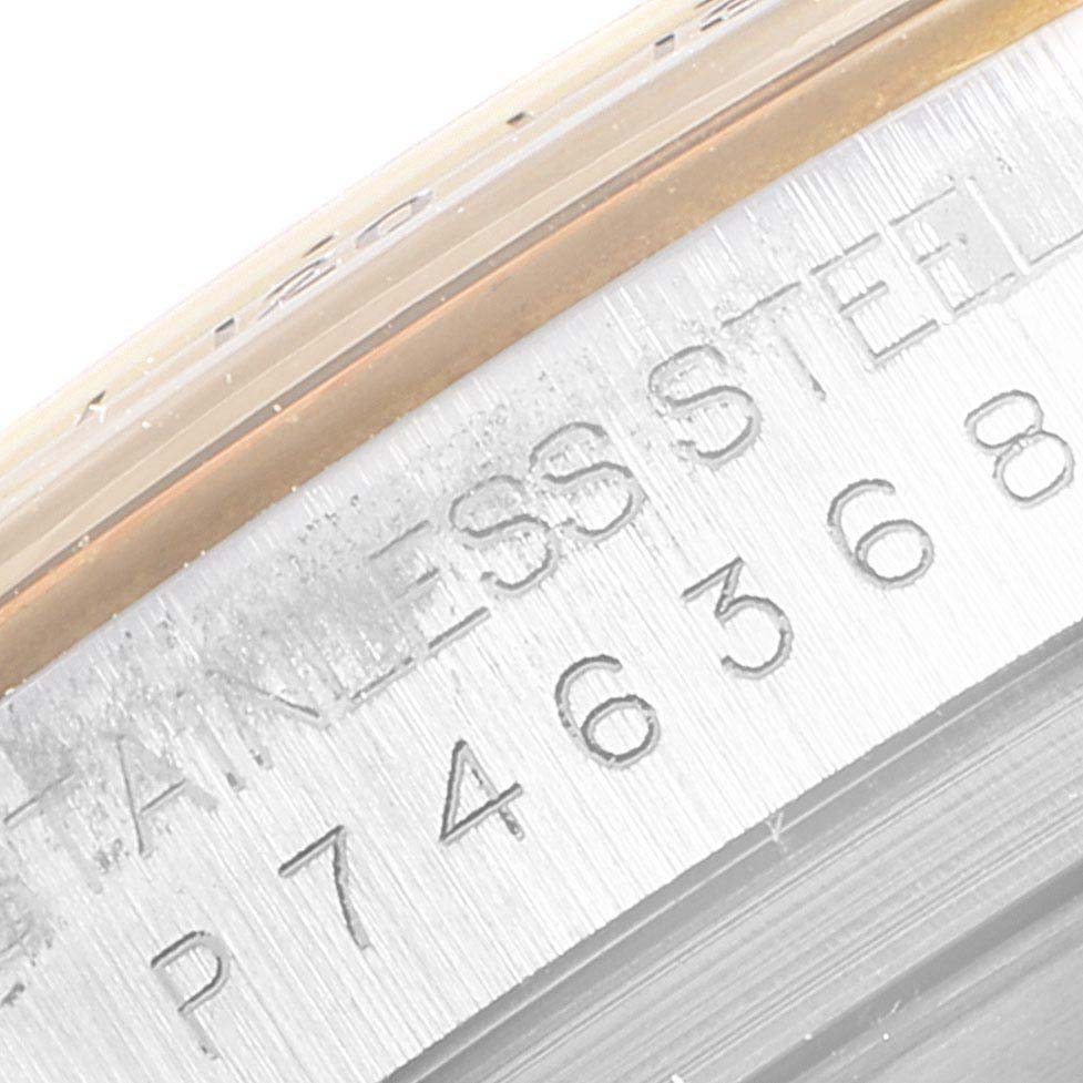 This image shows a close-up of the stainless steel engraving and part of the bezel of a Rolex Daytona 116523 Men
s Steel and Gold (two tone) Champagne Dial 116523 Men
s Steel and Gold (two tone) Champagne Dial watch.