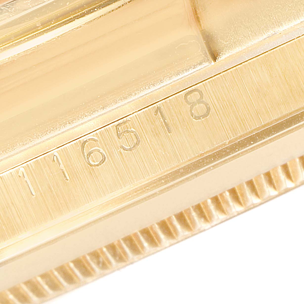 This image shows a close-up of the model number '116518' etched on the side of a Rolex Daytona 116518 Men's Yellow Gold Mother of Pearl Dial 116518 Men's Yellow Gold Mother of Pearl Dial watch case.
