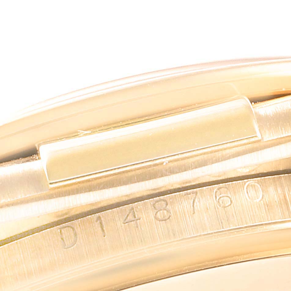 This image shows a close-up of the serial number engraved on the watch case of a Rolex Daytona 116518 Men's Yellow Gold Mother of Pearl Dial 116518 Men's Yellow Gold Mother of Pearl Dial model.