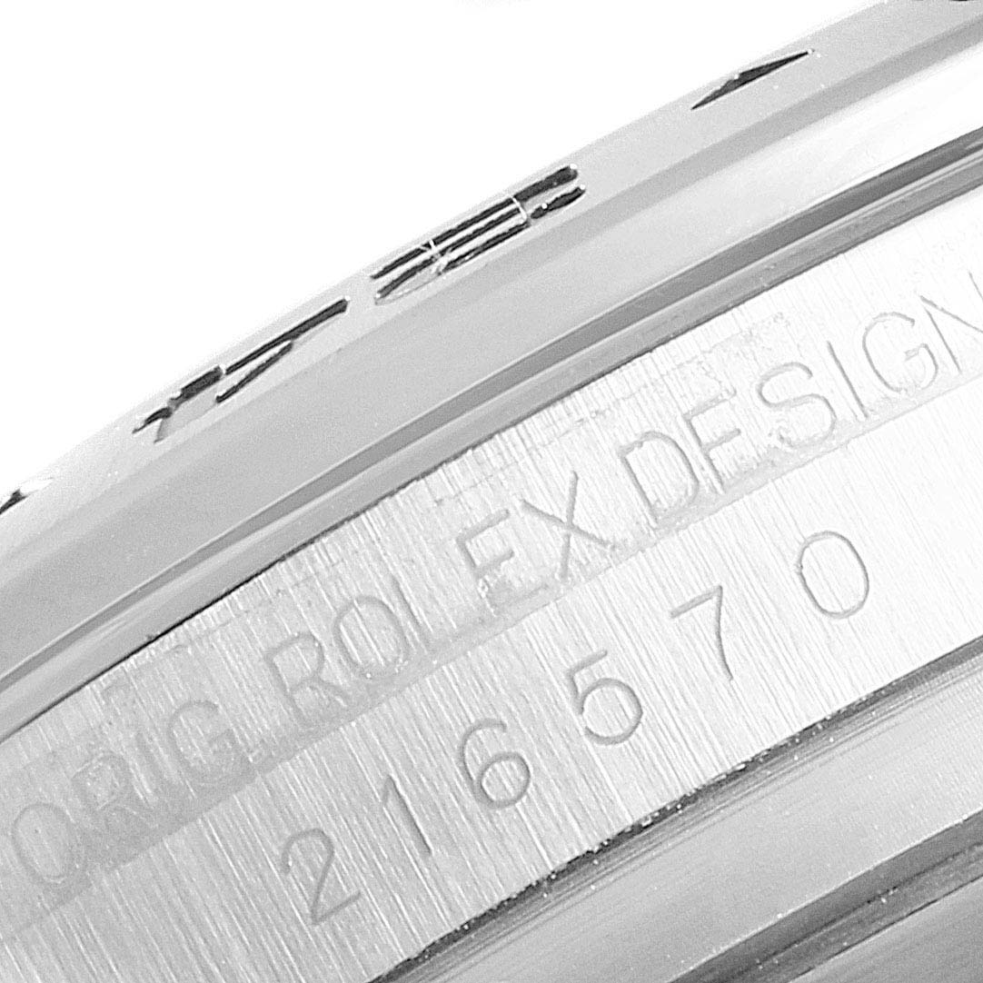 This image shows a close-up of the engraved case number and "Rolex Design" text on a Rolex Explorer 216570 Men
s Stainless Steel Black Dial 216570 Men
s Stainless Steel Black Dial watch bezel.