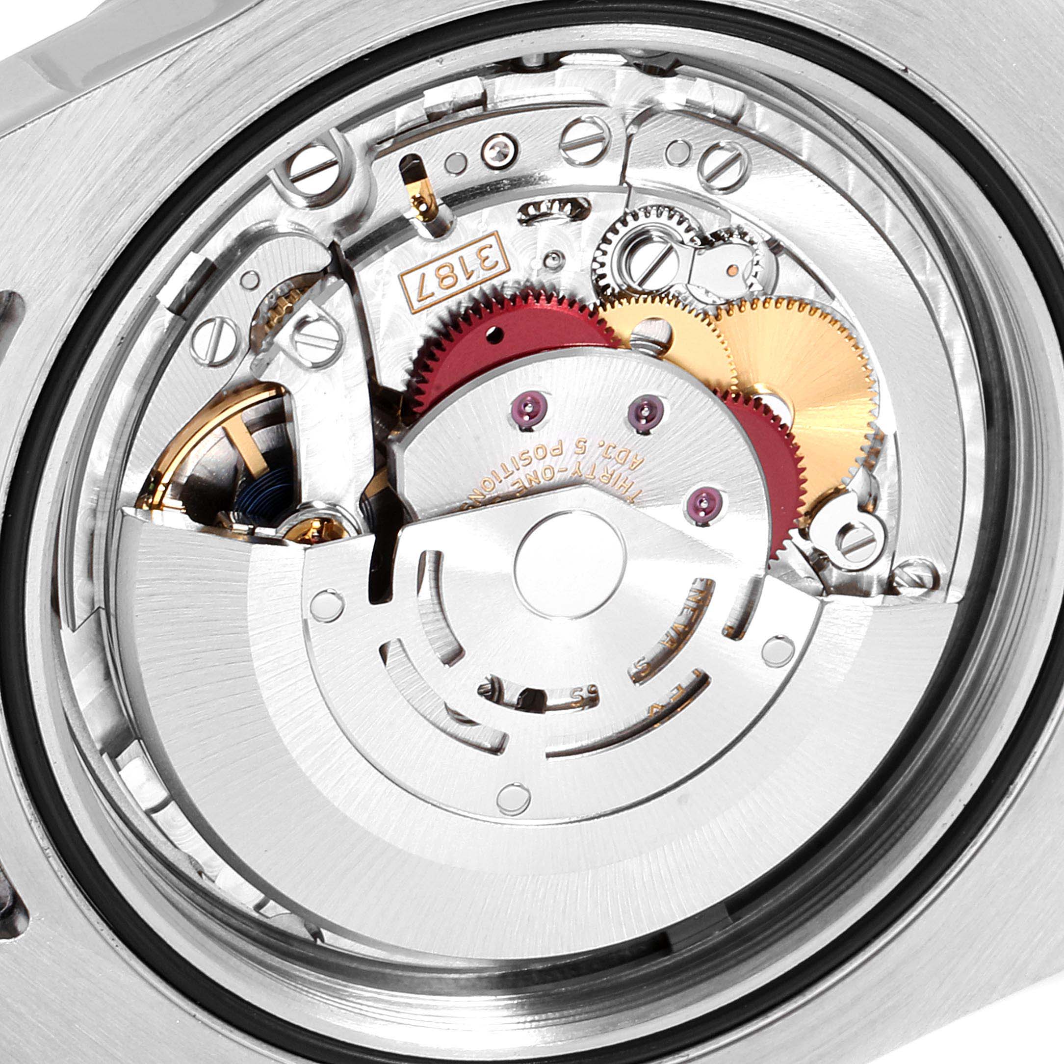 The image shows an up-close view of the internal mechanism of a Rolex Explorer 216570 Men
s Stainless Steel Black Dial 216570 Men
s Stainless Steel Black Dial watch, particularly the movement and gears.