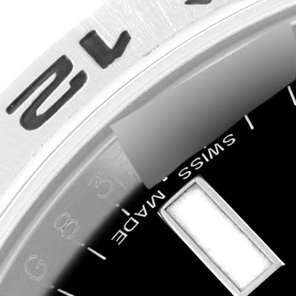 The image shows a close-up of the bezel and "Swiss Made" label on the dial of a Rolex Explorer 216570 Men
s Stainless Steel Black Dial 216570 Men
s Stainless Steel Black Dial watch.