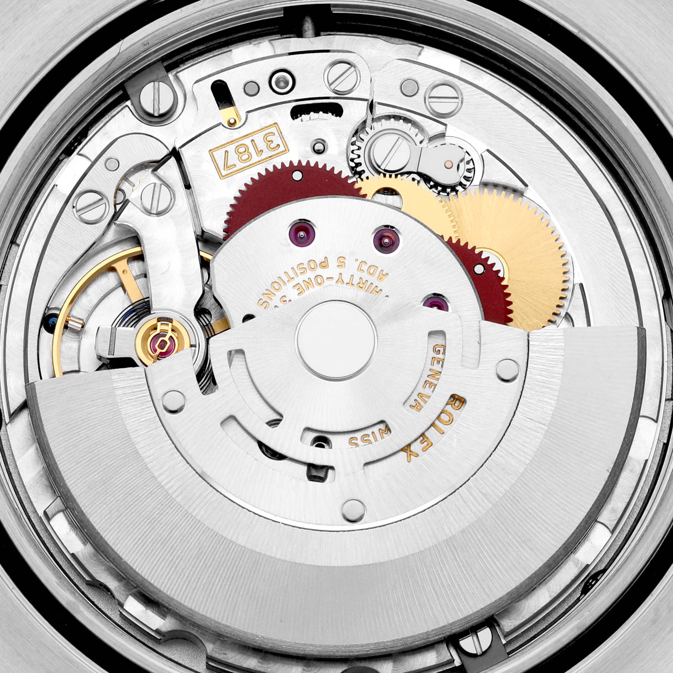 The image shows an internal view of the movement mechanism of a Rolex Explorer 216570 Men
s Stainless Steel Black Dial 216570 Men
s Stainless Steel Black Dial watch, including gears and the rotor.