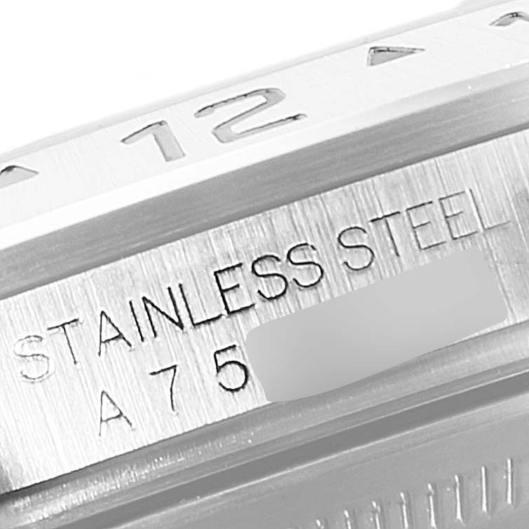 This zoomed-in image shows the stainless steel case of the Rolex Explorer 16570 Men's Stainless Steel Black Dial 16570 Men's Stainless Steel Black Dial model, including part of the bezel and engraved text.