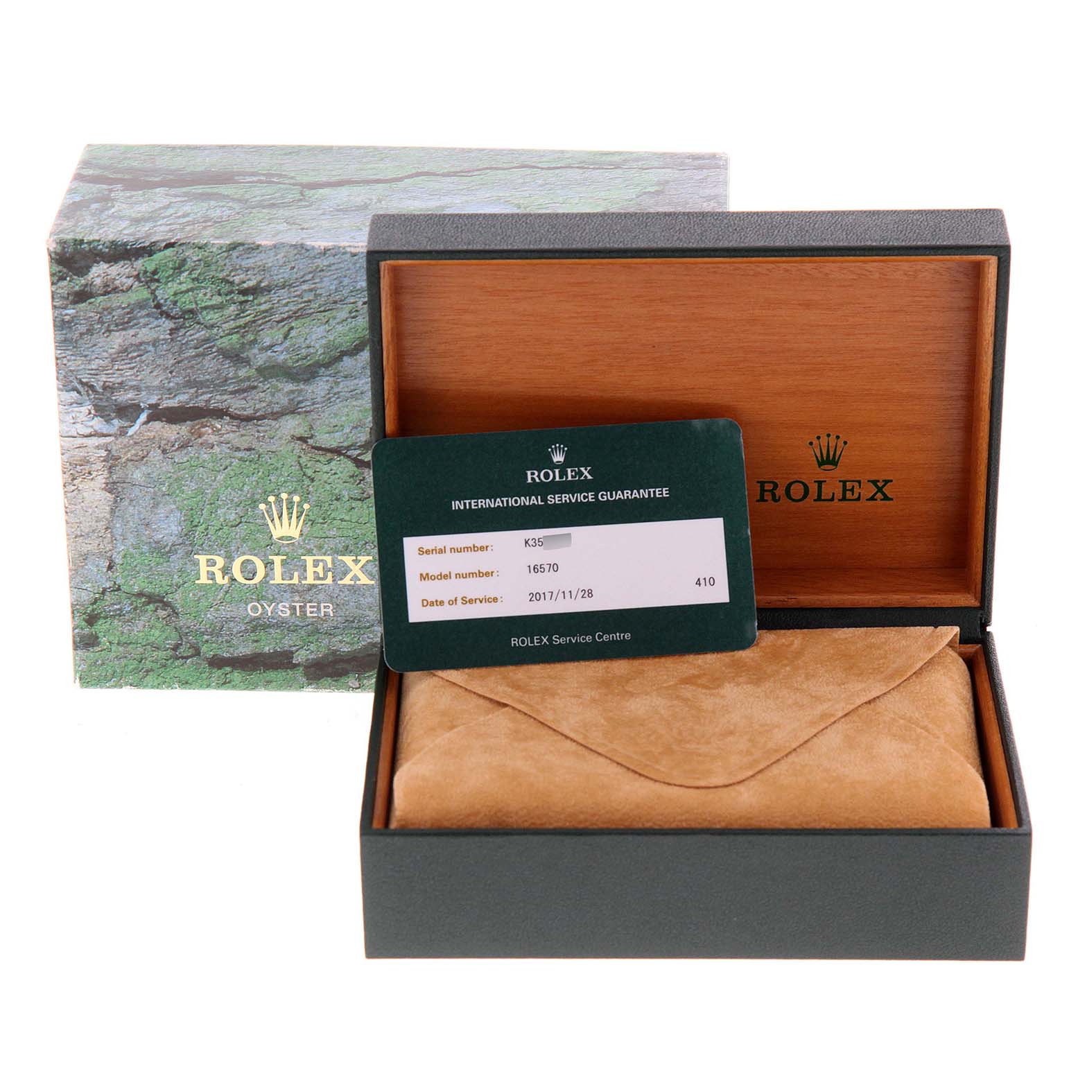 The image shows a Rolex Explorer 16570 Men
s Stainless Steel Black Dial 16570 Men
s Stainless Steel Black Dial watch case with the box lid open, revealing a service guarantee card and a suede pouch inside.