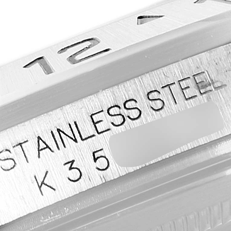The image shows a close-up of the bezel and engraved text on the side of the case of a Rolex Explorer 16570 Men
s Stainless Steel Black Dial 16570 Men
s Stainless Steel Black Dial watch.